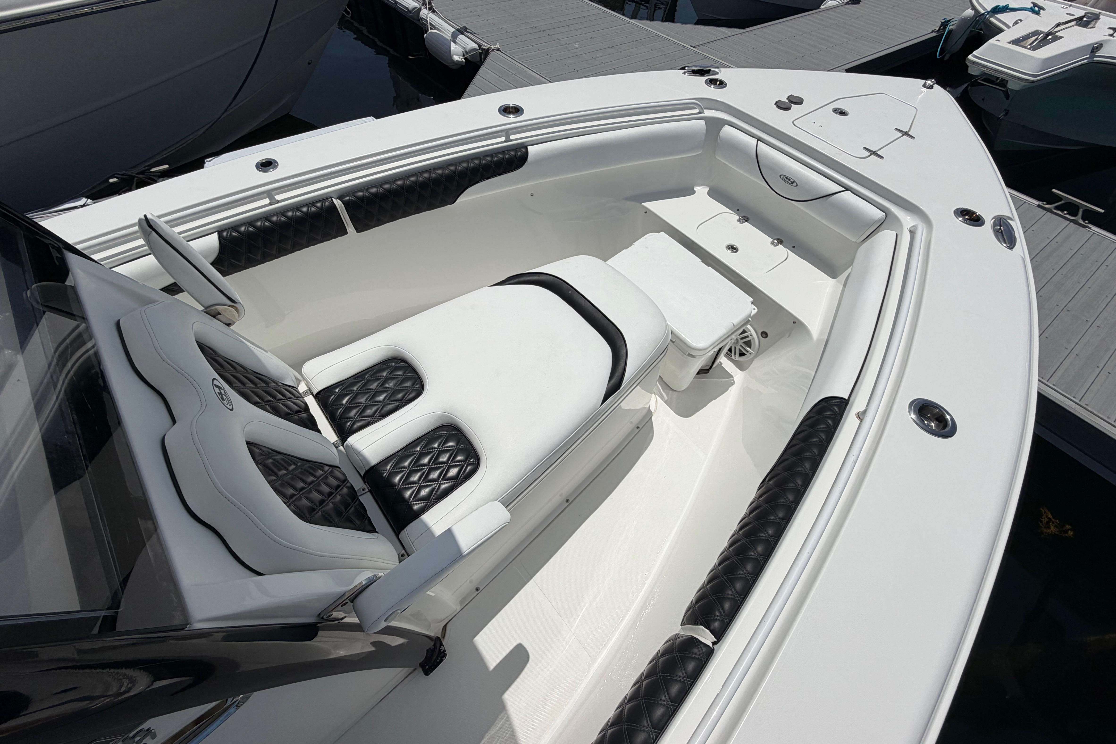 2019 Sea Hunt Gamefish 27 Coffin Box boat interior with cushioned seating and storage.