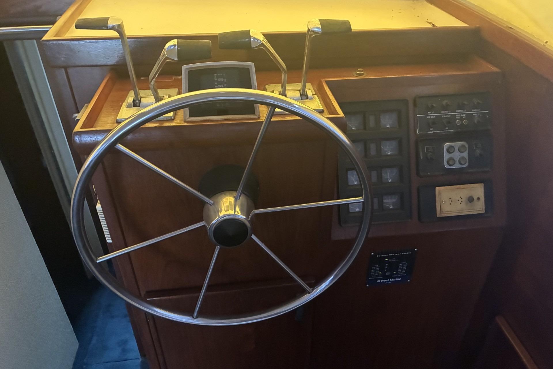 Helm of 1980 Chris-Craft 360 Commander with steering wheel and control panel.