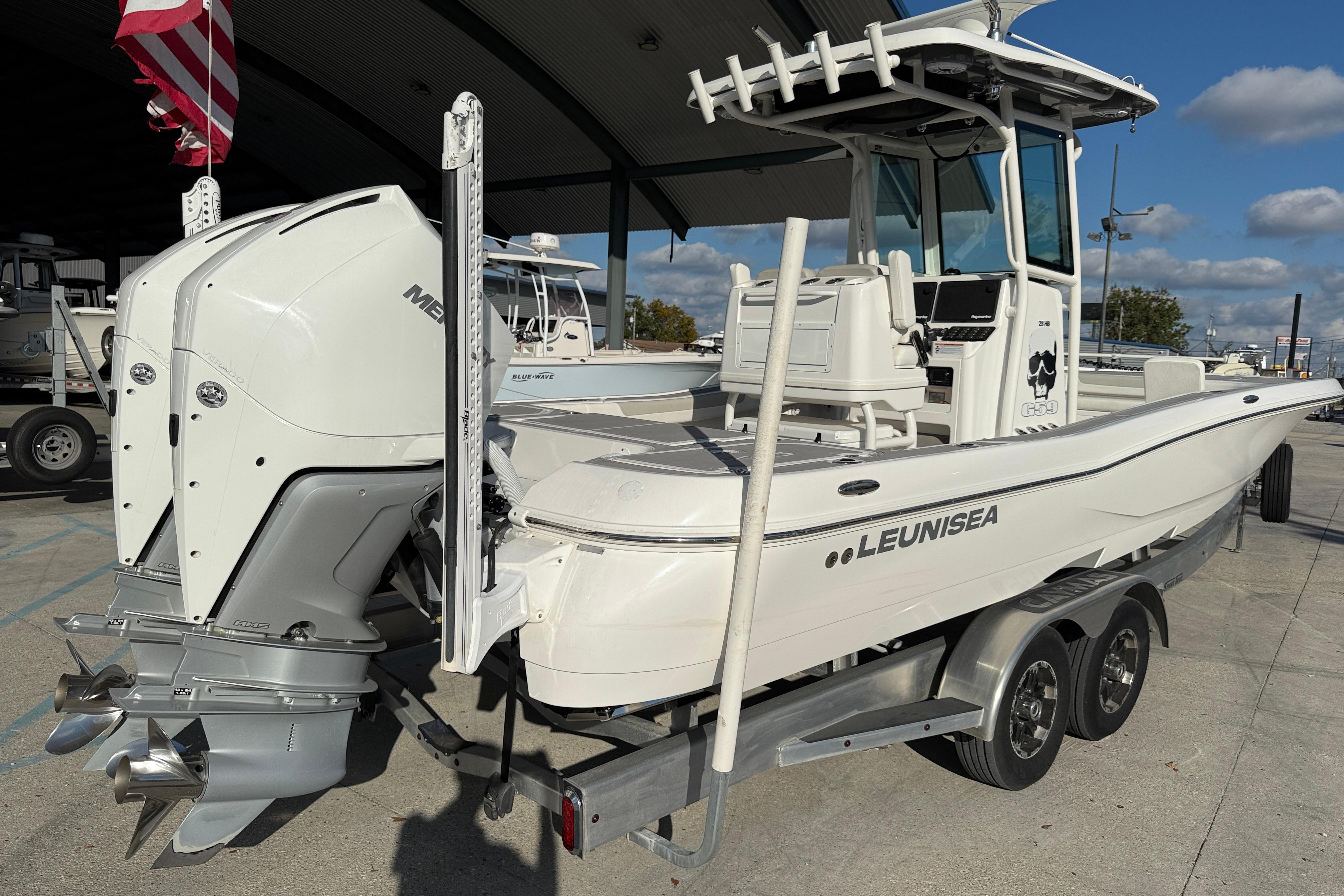 2022 Caymas 28 HB Twin boat with dual Mercury engines on a trailer.