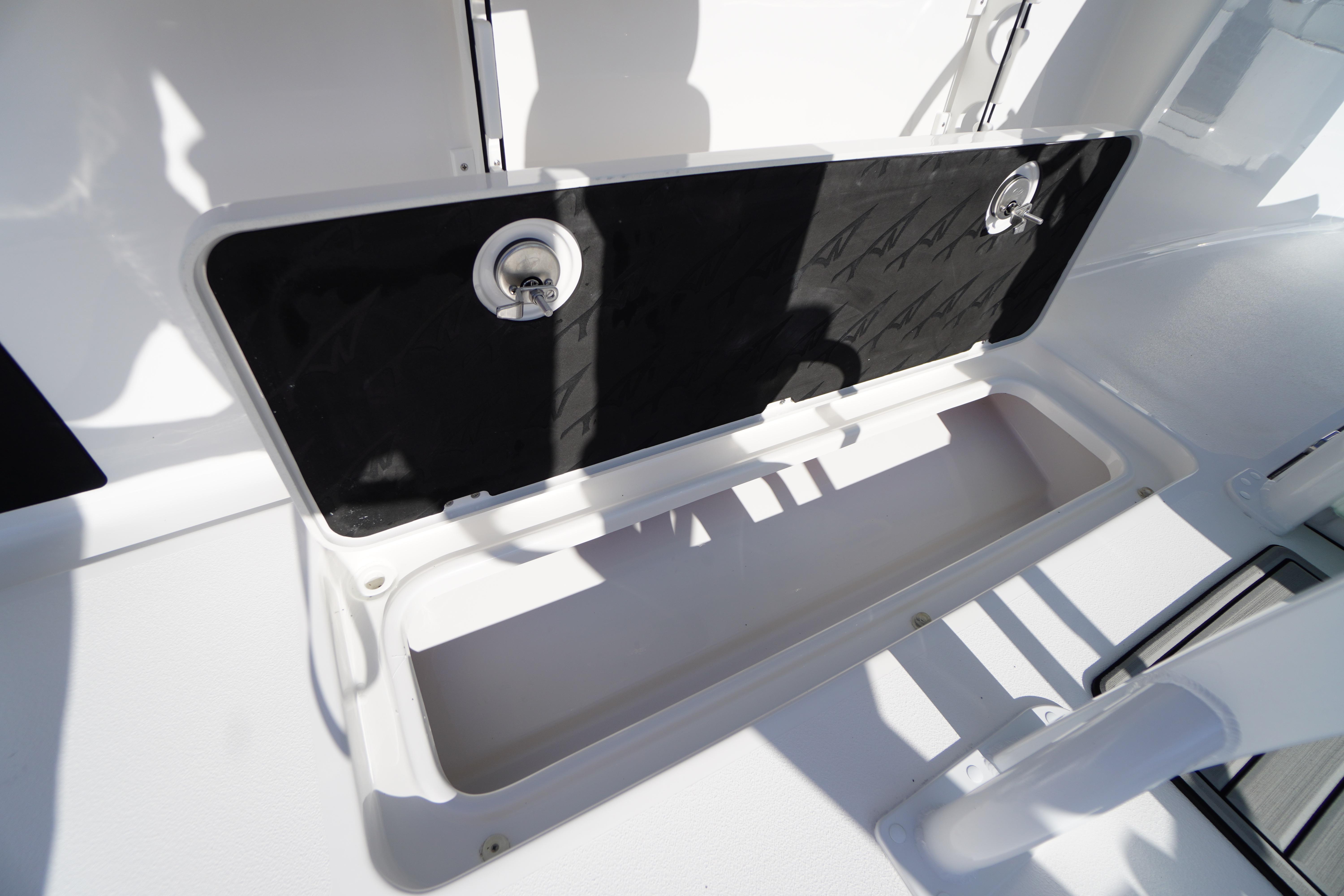 2026 Tidewater 272 LXF boat storage compartment with open hatch and secure latch.