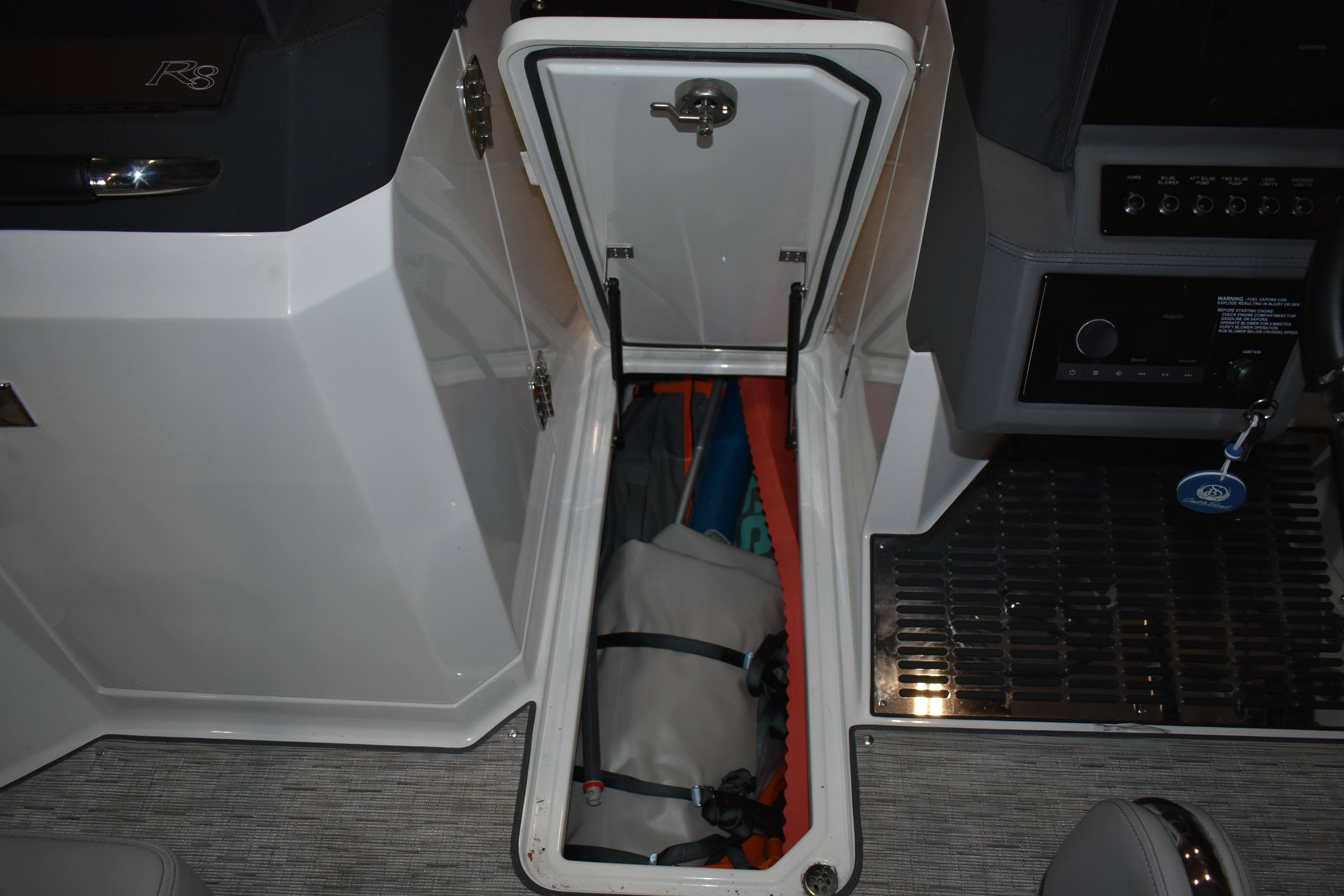 Storage compartment in 2023 Cobalt R8 boat, featuring organized interior space.
