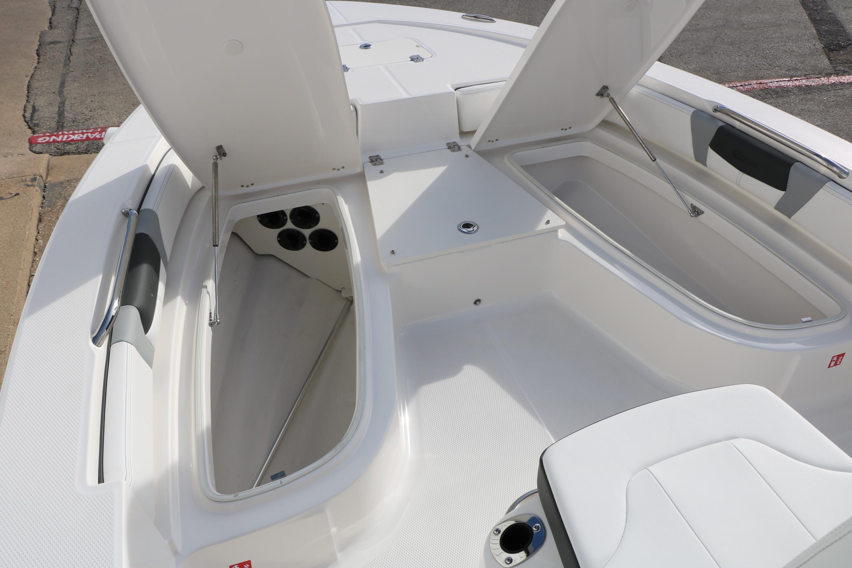 2026 Robalo 206 Cayman boat with open storage compartments and seating area.