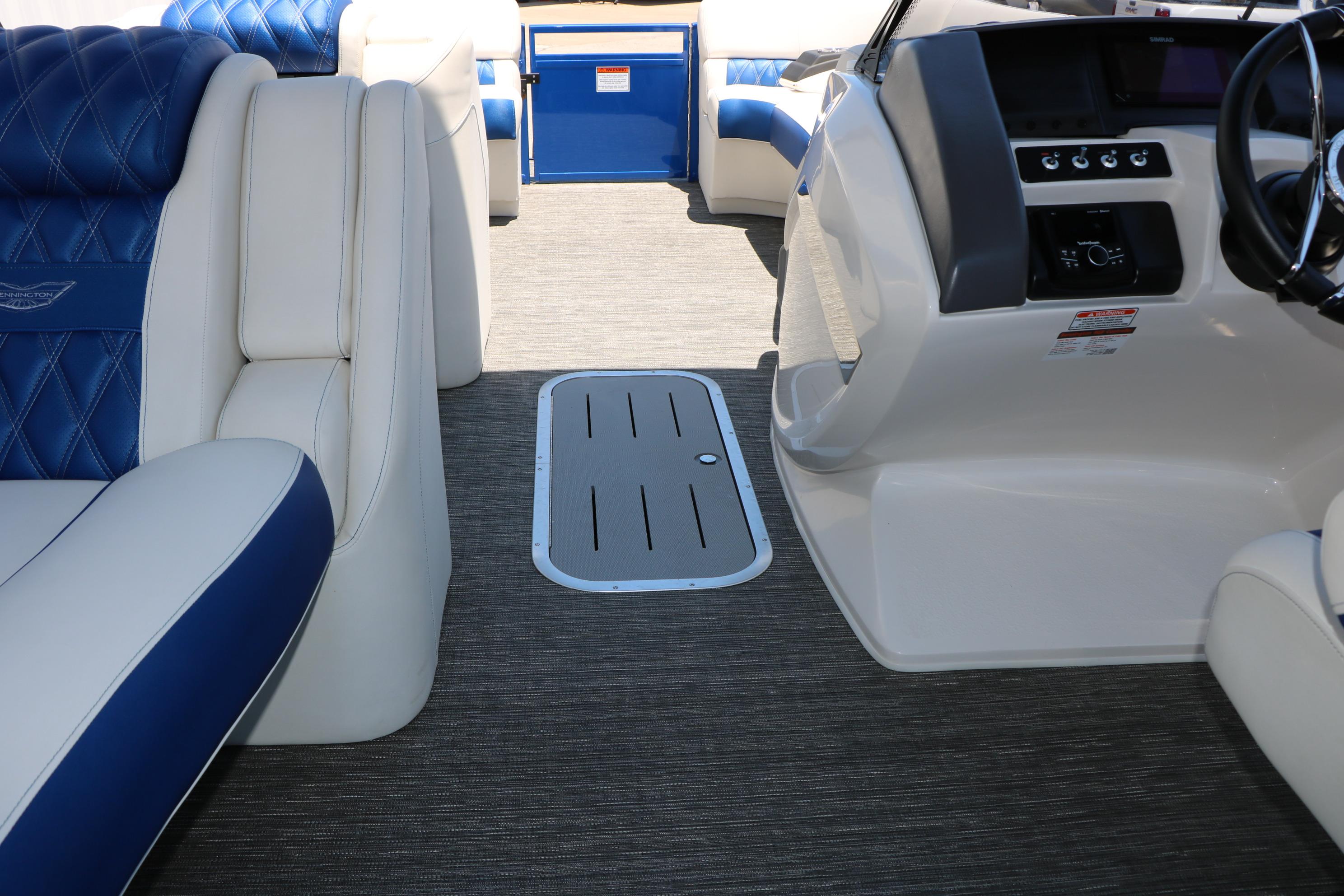 2024 Bennington 23 RX Swingback interior with blue and white seating and modern dashboard.
