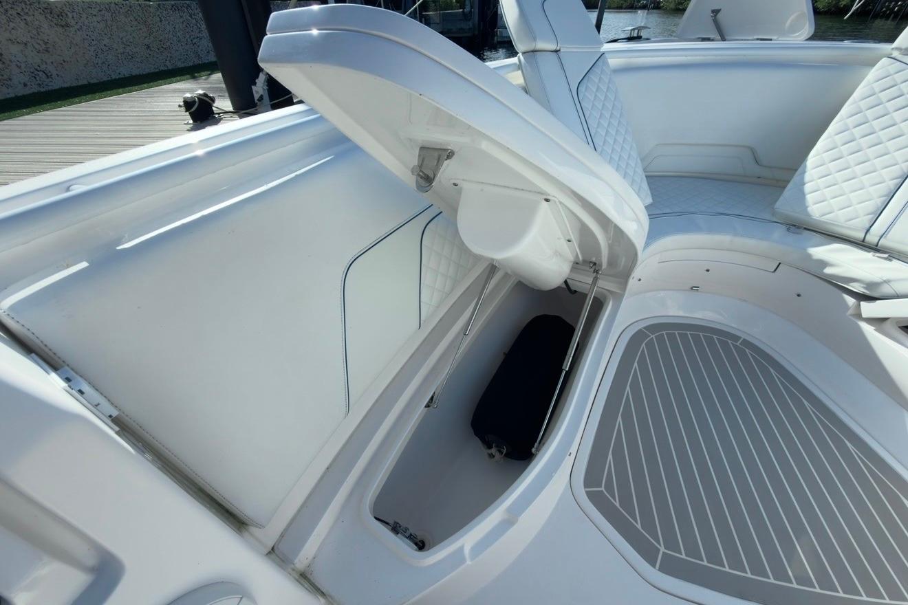 2022 Intrepid 407 Panacea boat interior with open storage compartment and cushioned seating.