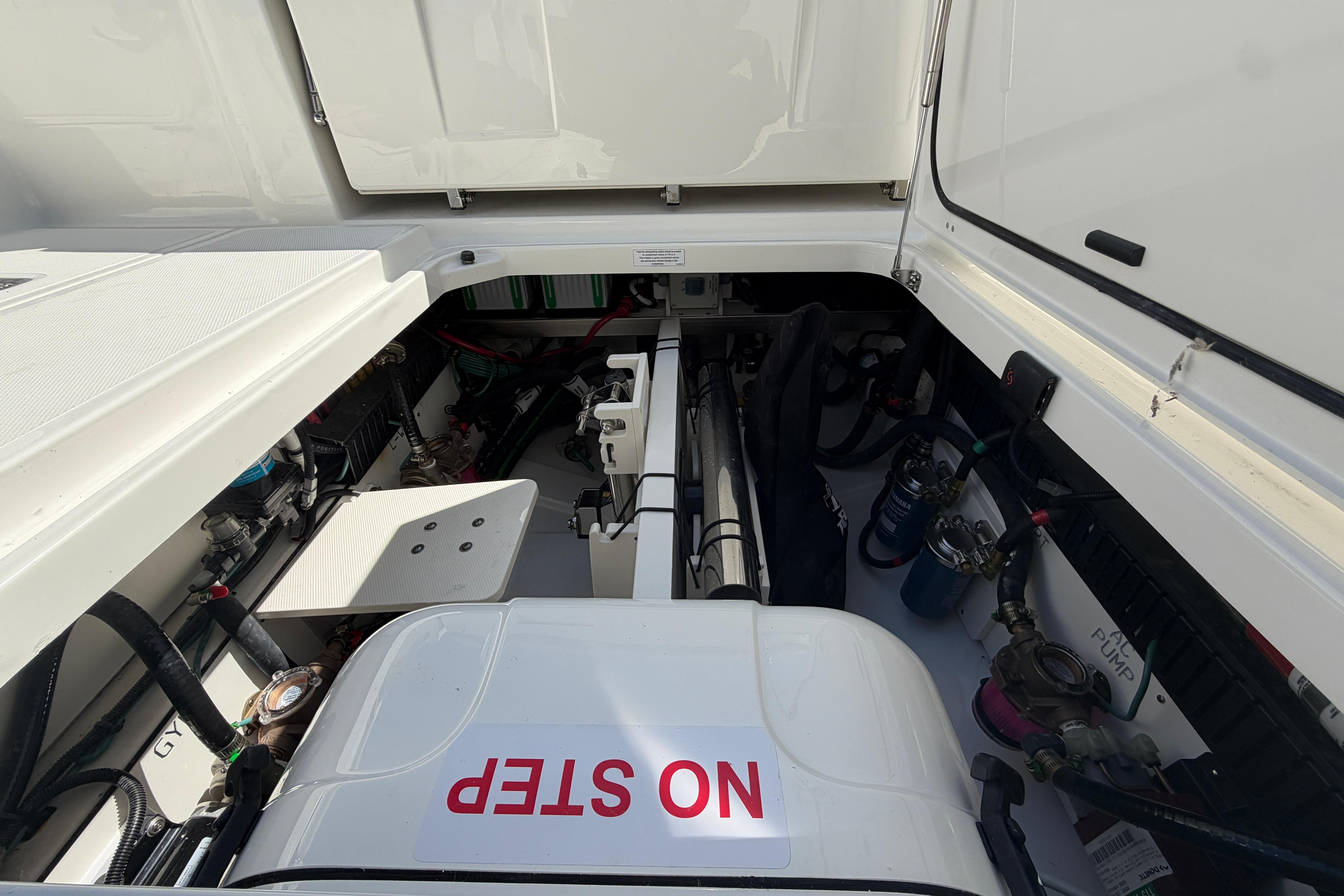 Engine compartment of 2026 Pursuit S 358 Sport boat, featuring "NO STEP" warning.