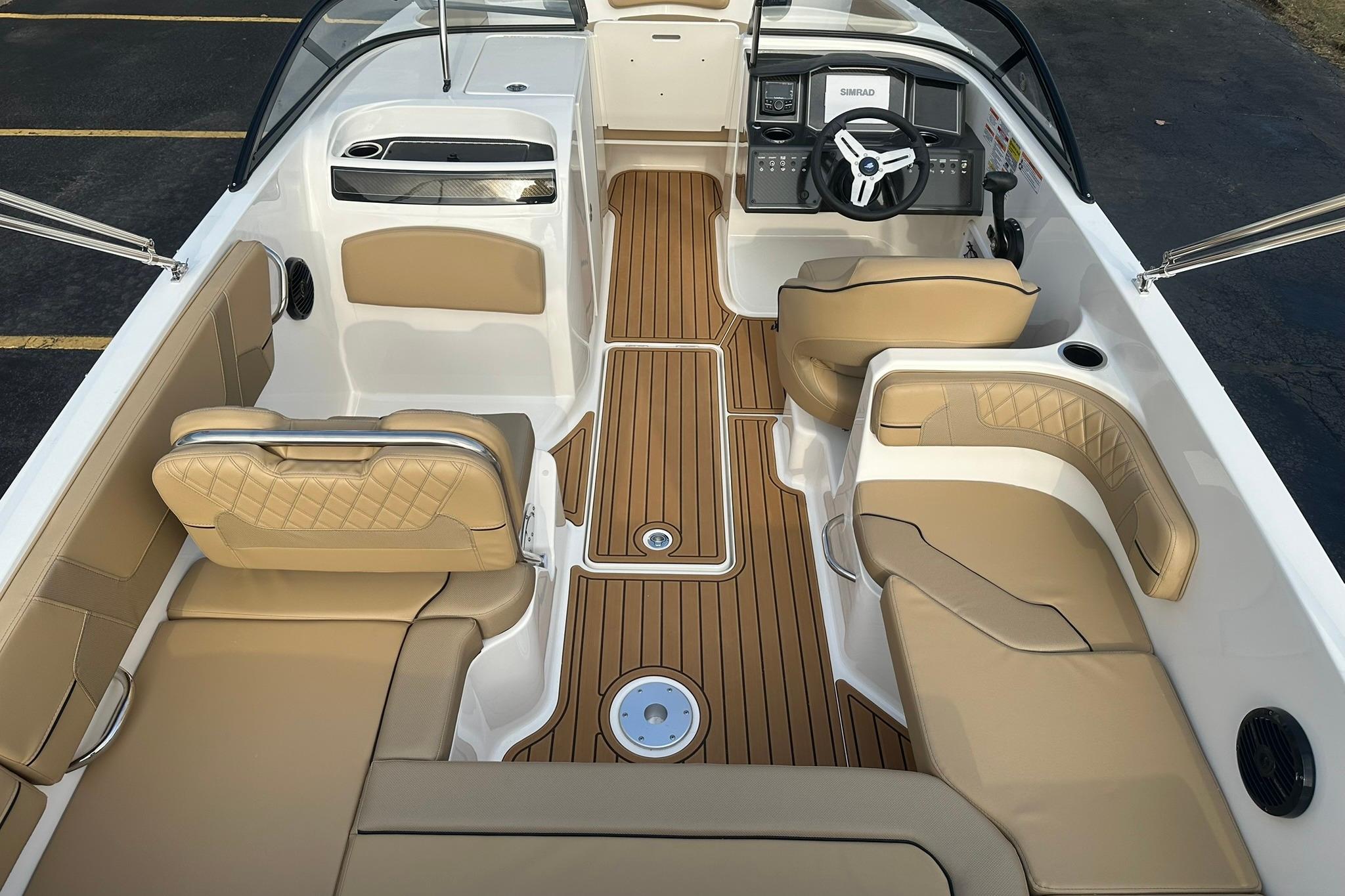 2026 Bayliner VR6 Bowrider OB interior with tan seating and wood-style flooring.