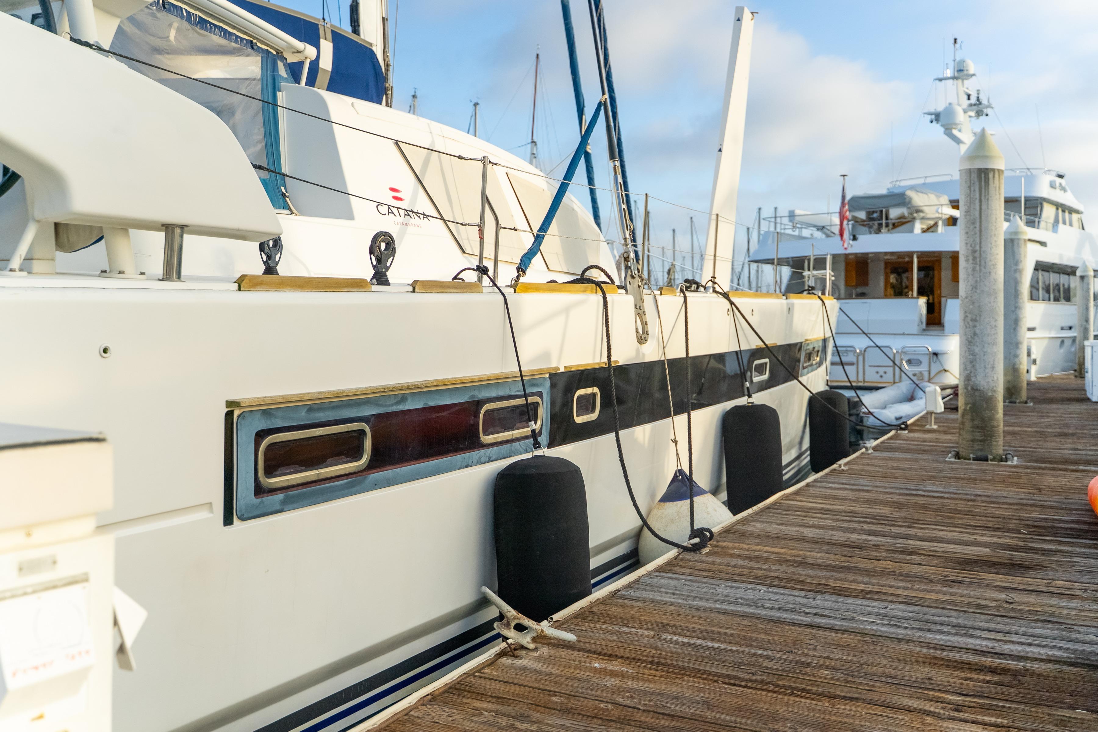 2009 Catana 65 yacht docked at a marina, showcasing sleek design and modern features.