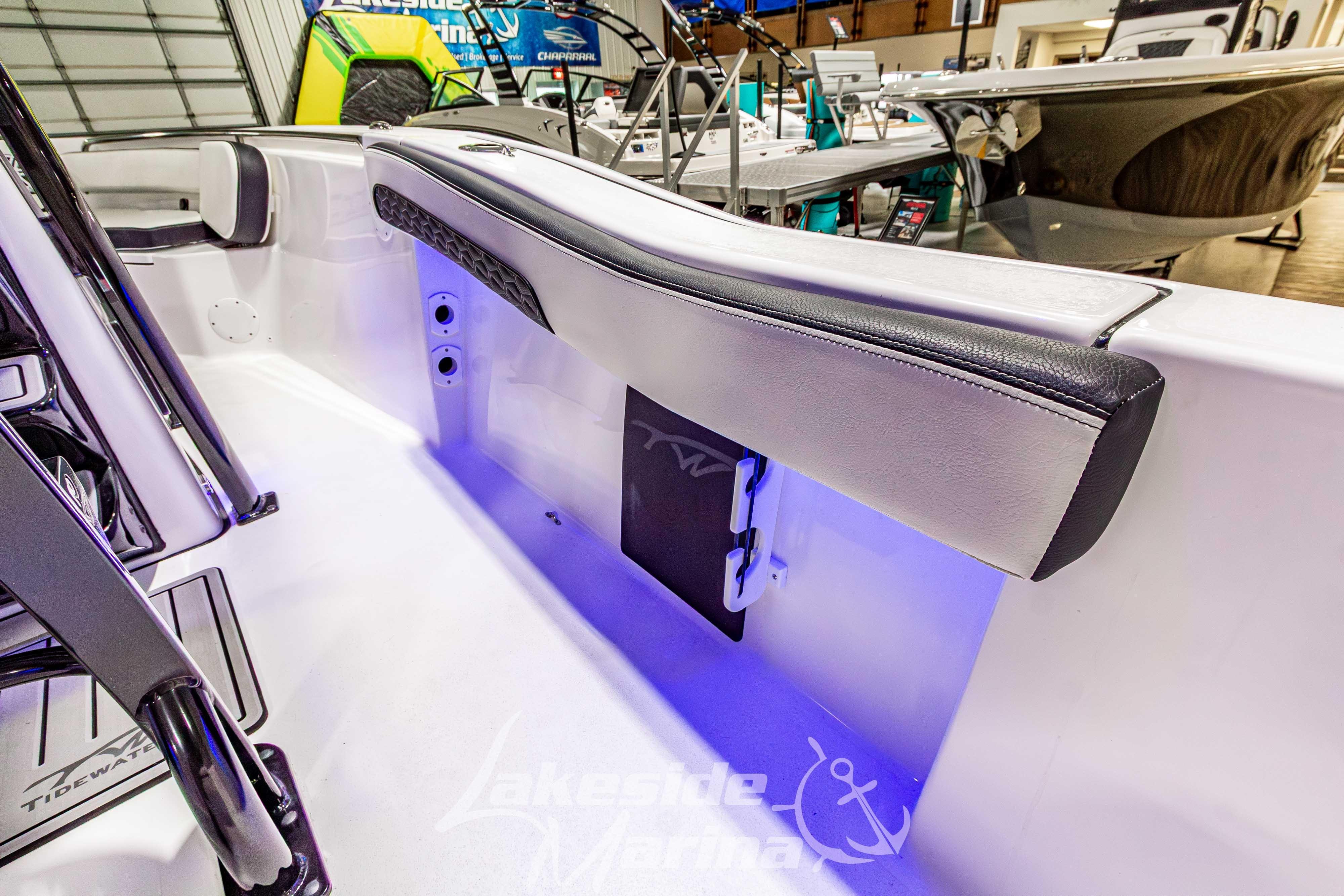 2026 Tidewater 210 CC Adventure boat interior with blue LED lighting and sleek seating.
