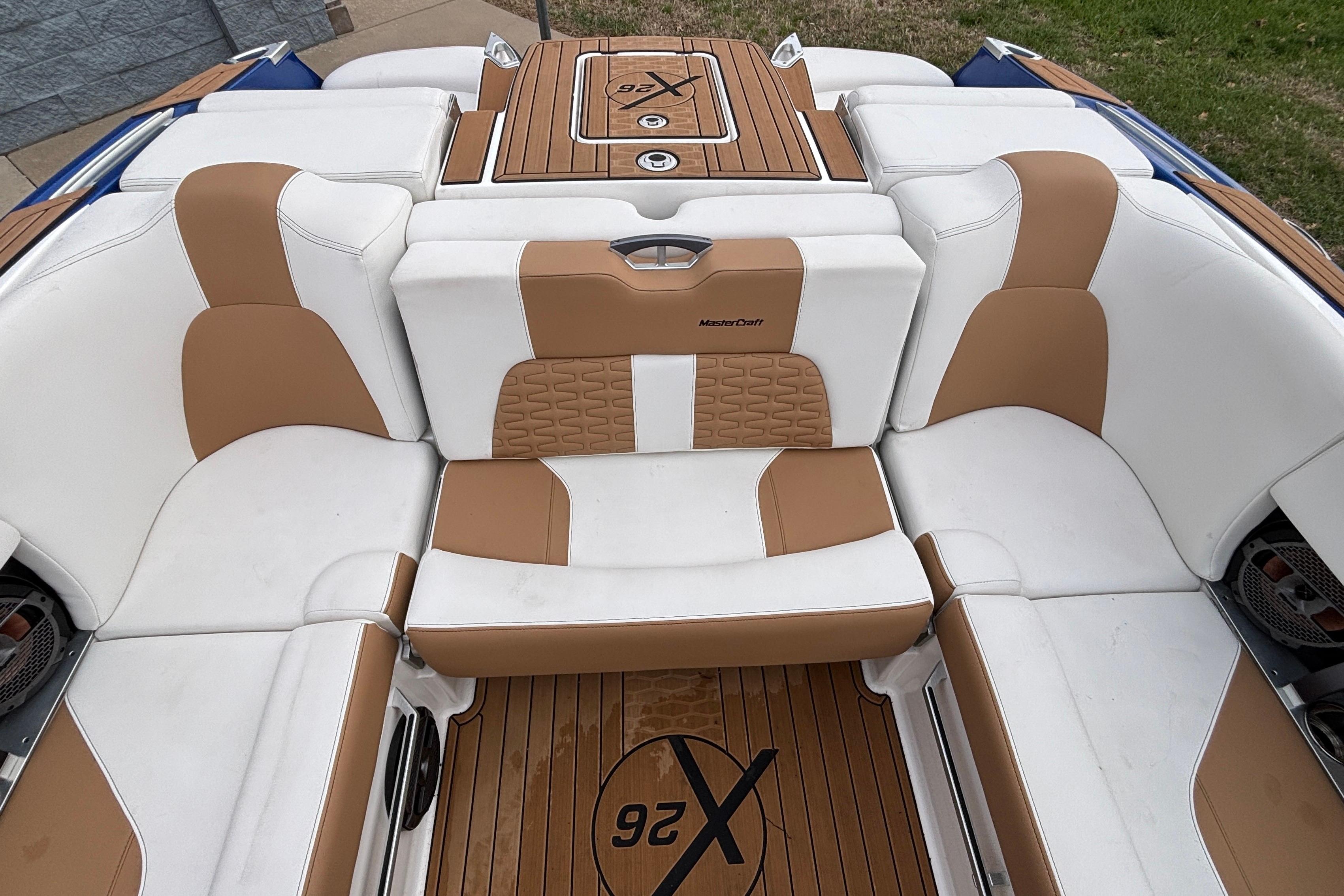 2022 MasterCraft X26 boat interior with tan and white seating, teak flooring.