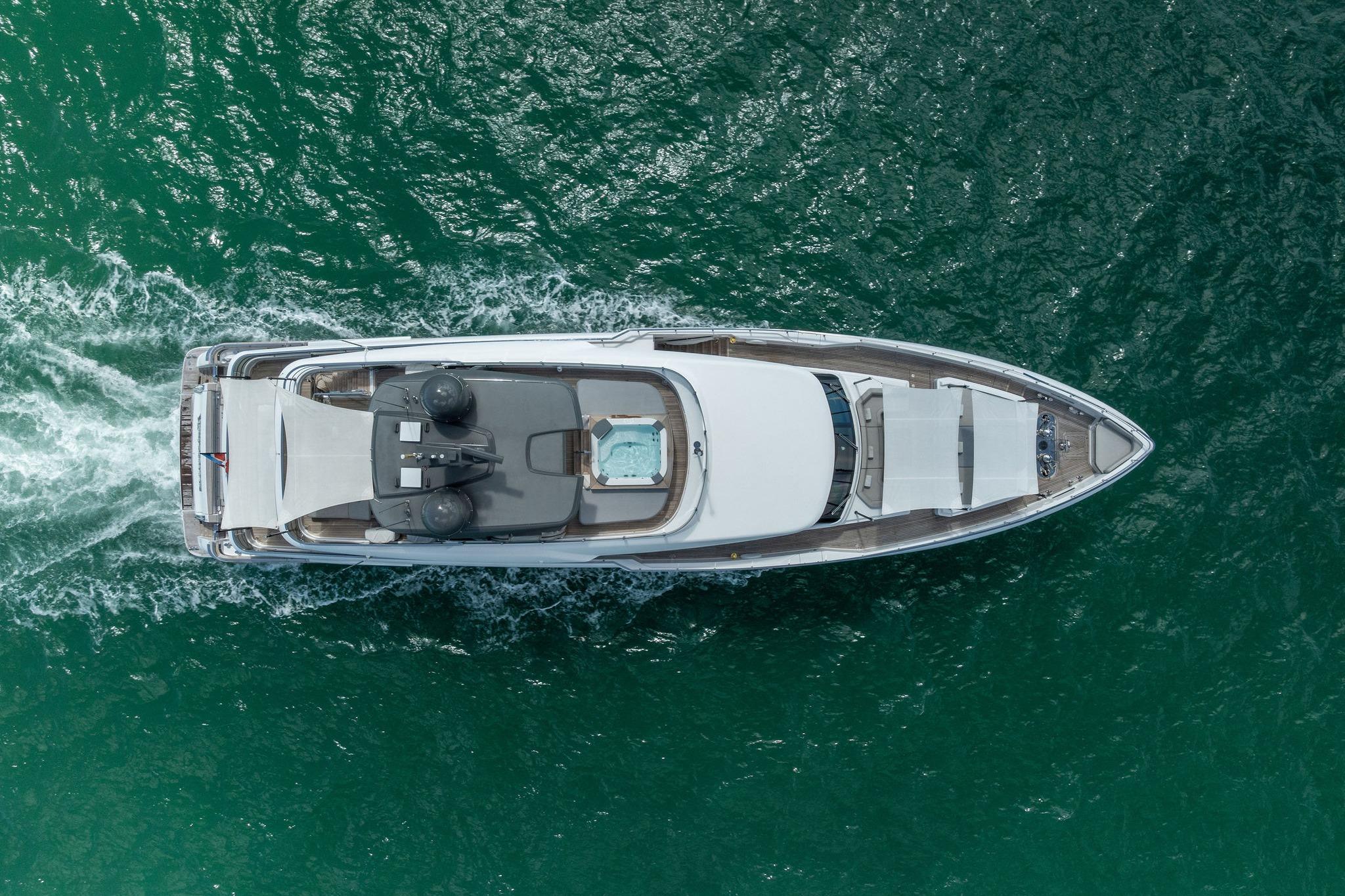 Aerial view of 2023 Custom Line Navetta 33 yacht cruising on open water.
