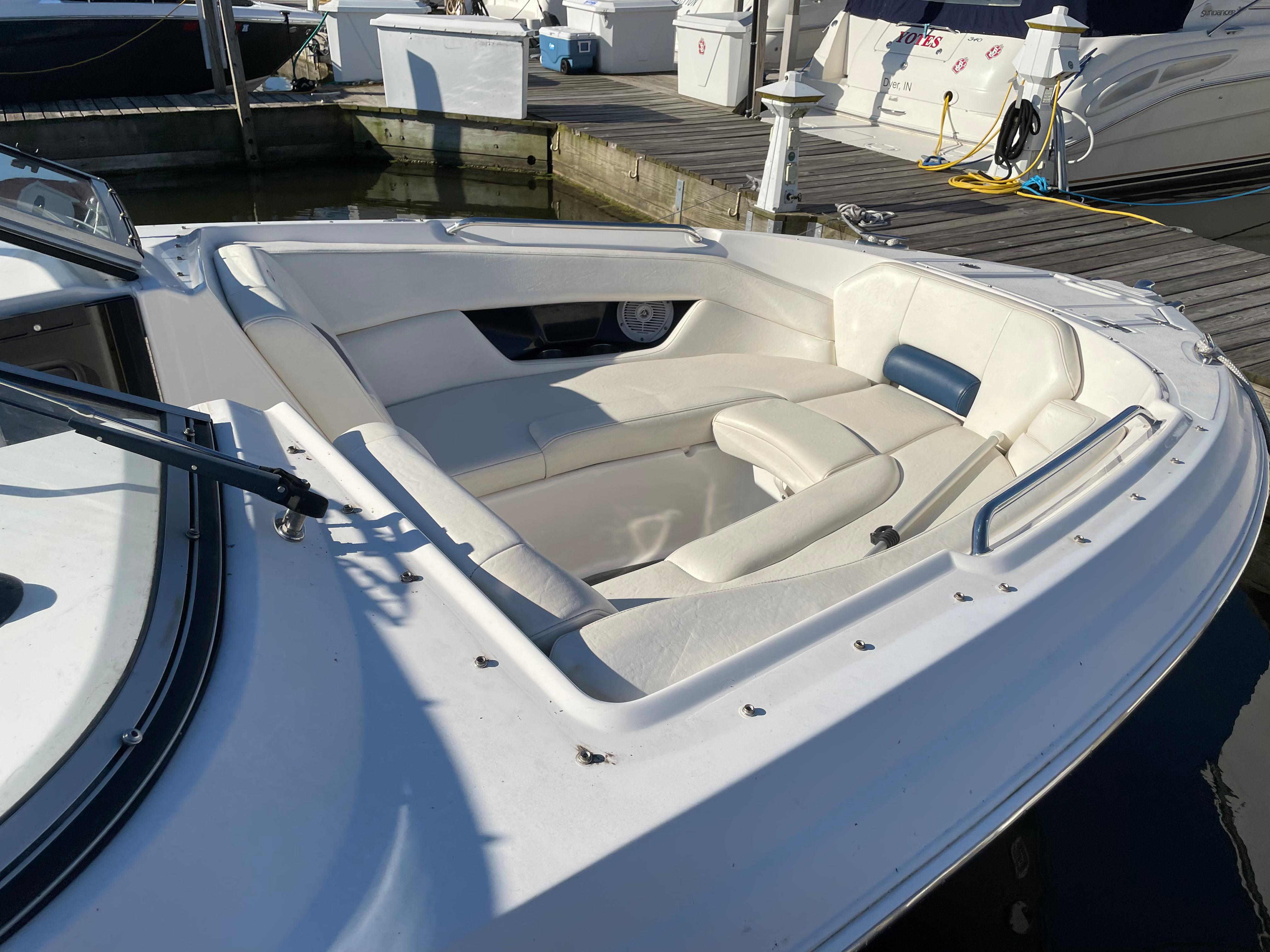 2008 Regal 2700 Bowrider boat with spacious seating at a marina dock.