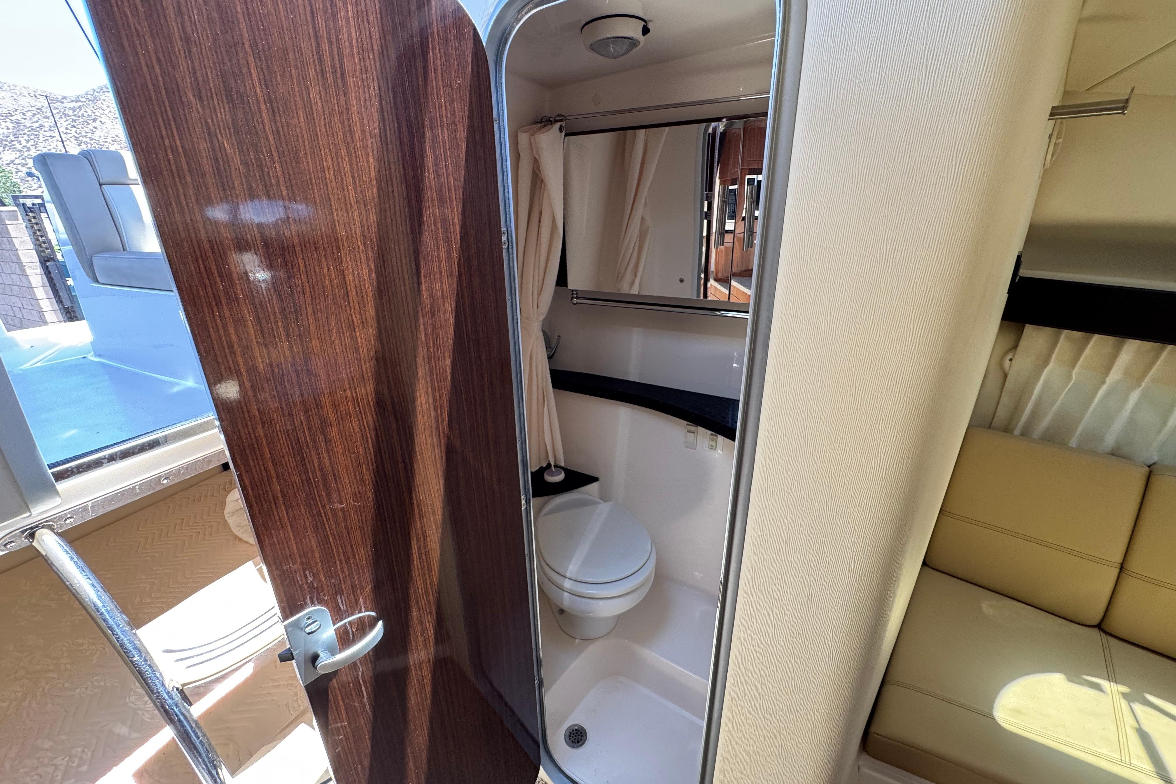 2013 Regal 28 Express boat interior showing bathroom and seating area.