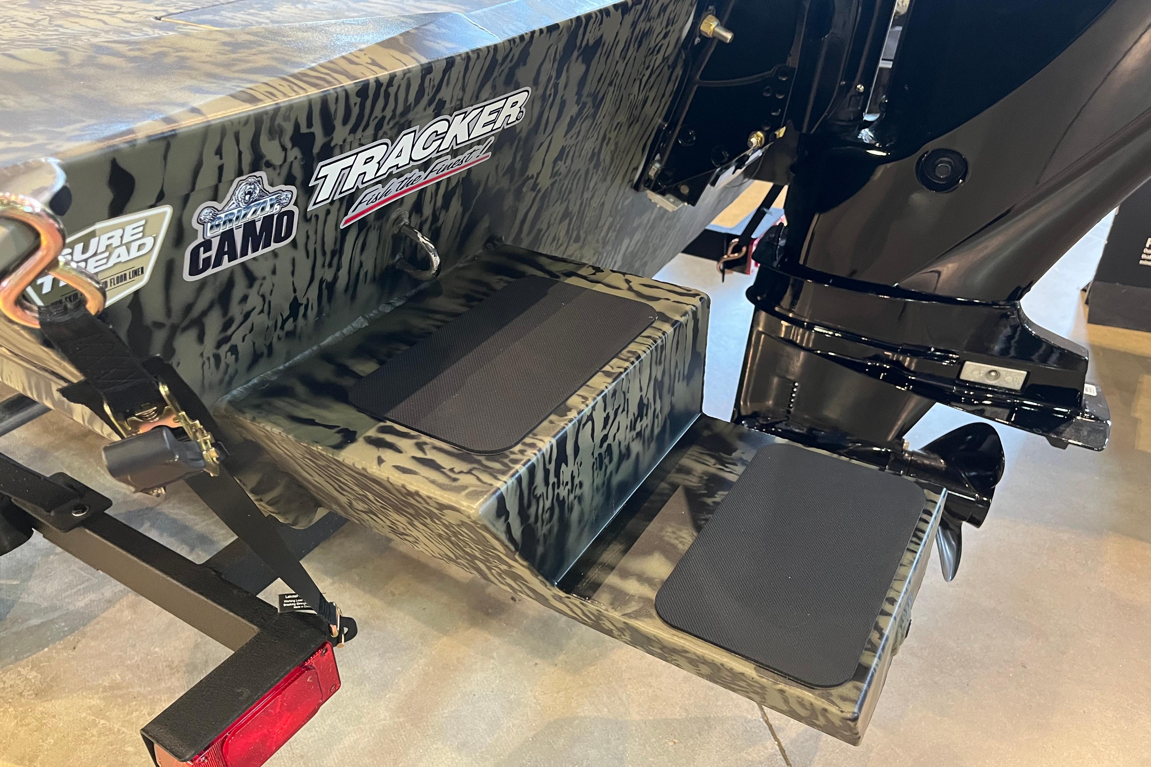 2026 Tracker Grizzly 1654 T Sportsman boat with camo design and motor detail.