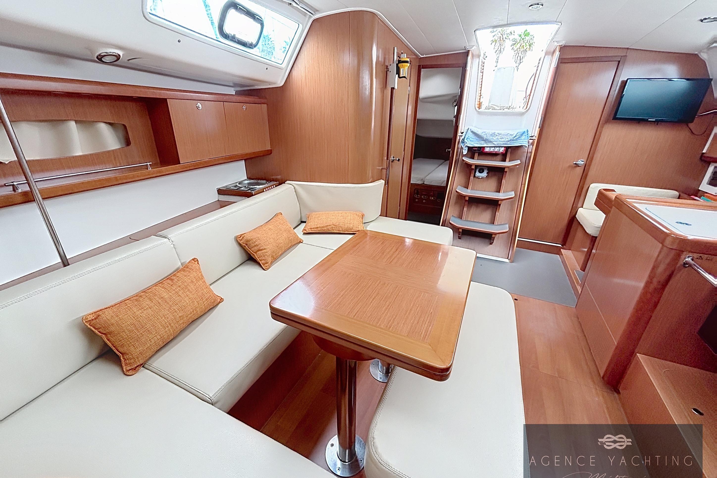 Interior of 2008 Beneteau Oceanis 40 yacht with elegant wood finish and cozy seating.