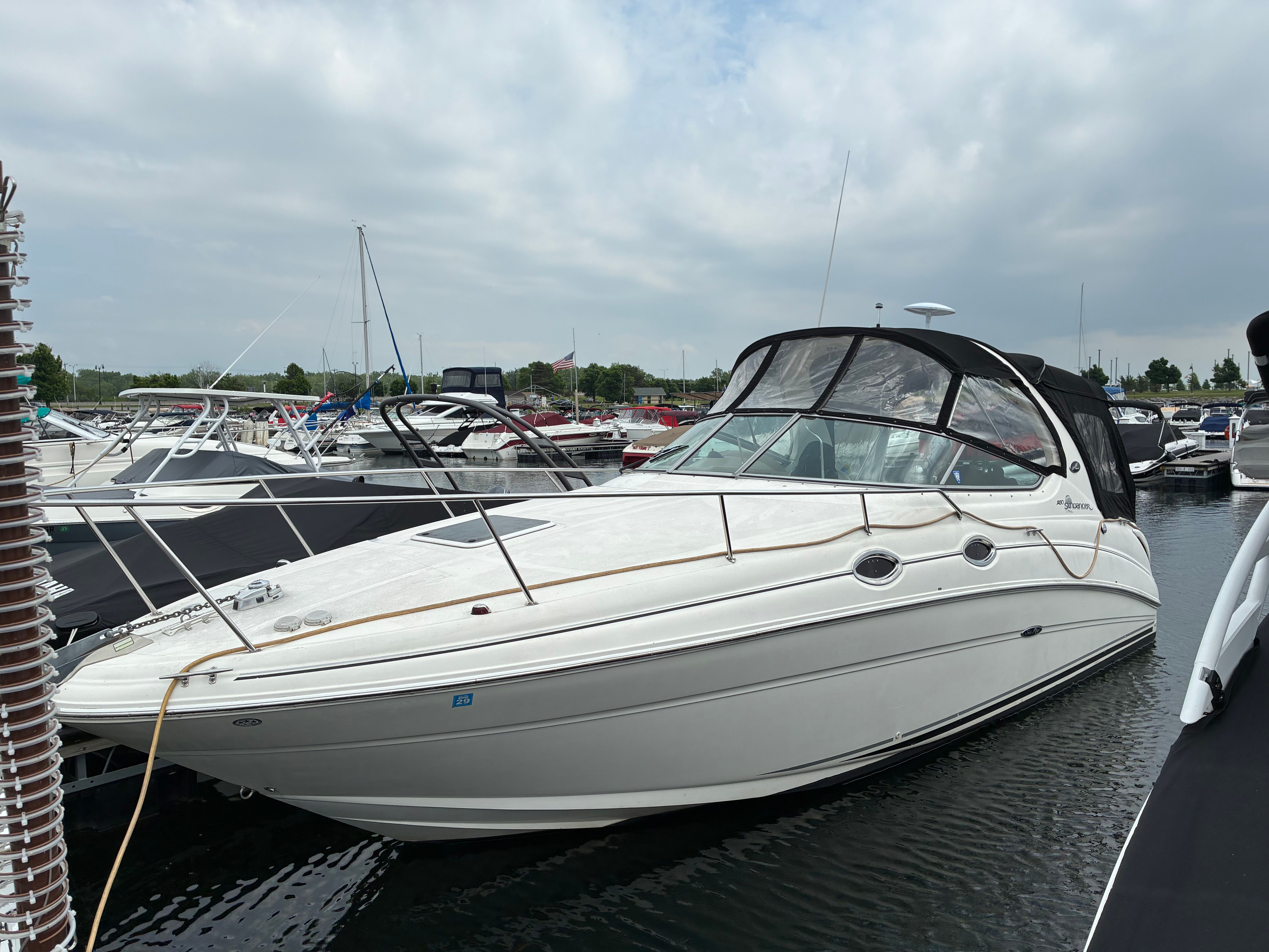 2004 Sea Ray Sundancer 280 docked, cloudy sky.