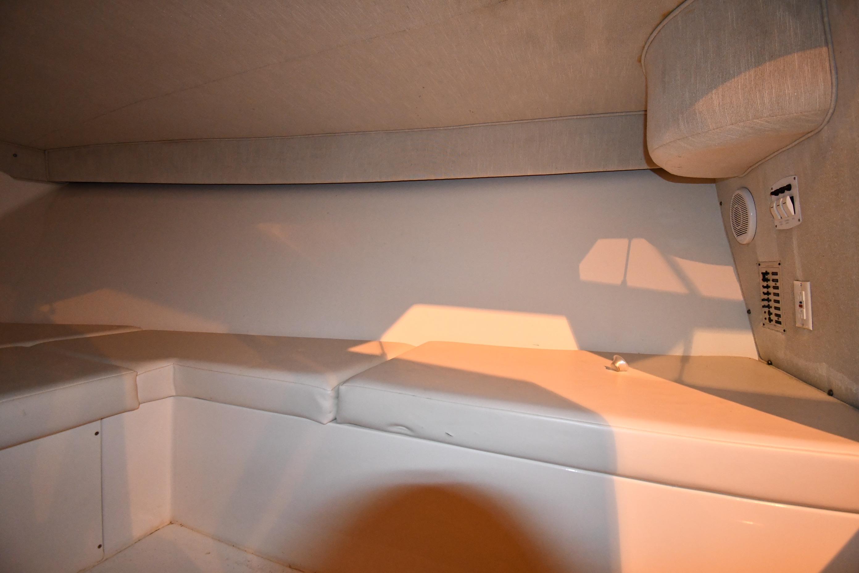 2001 Fountain 38 Center Console cabin interior with cushioned seating and control panel.