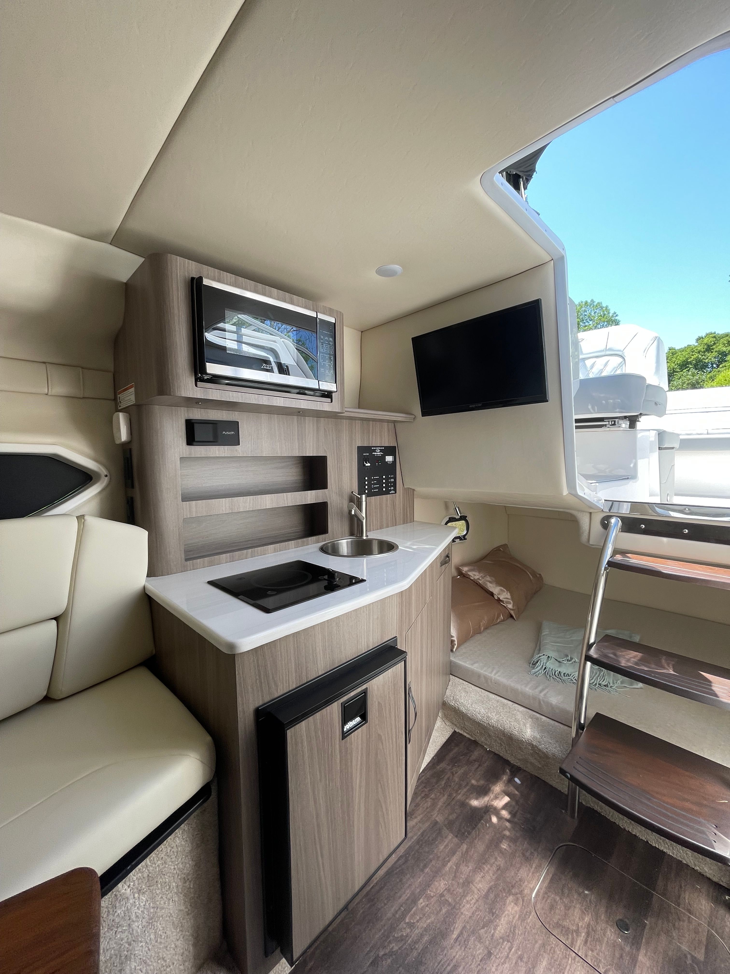 Interior of 2022 Regal 26 Express with kitchenette and seating area.