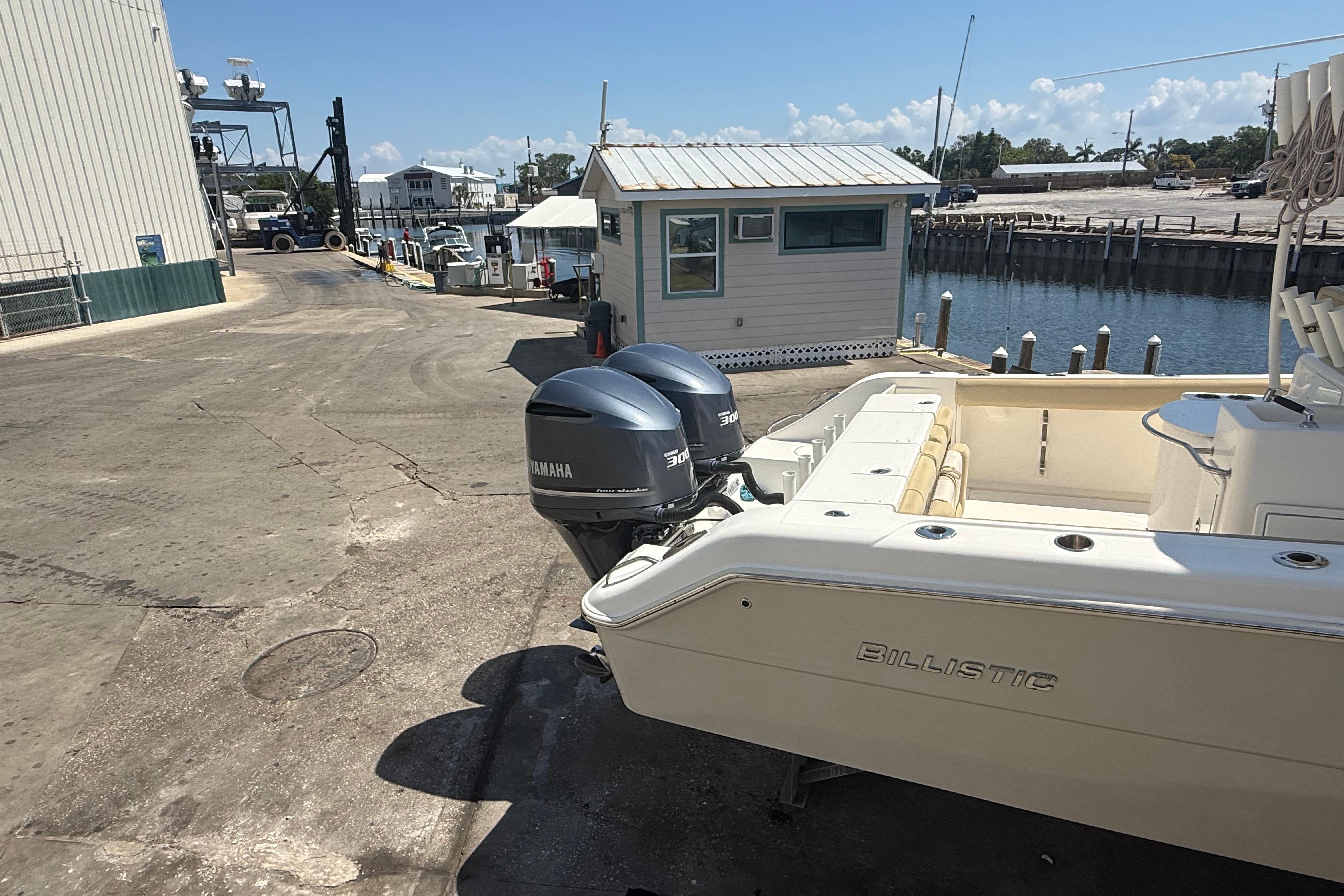2019 Key West Billistic 281 Center Console boat with Yamaha engines at a dock.
