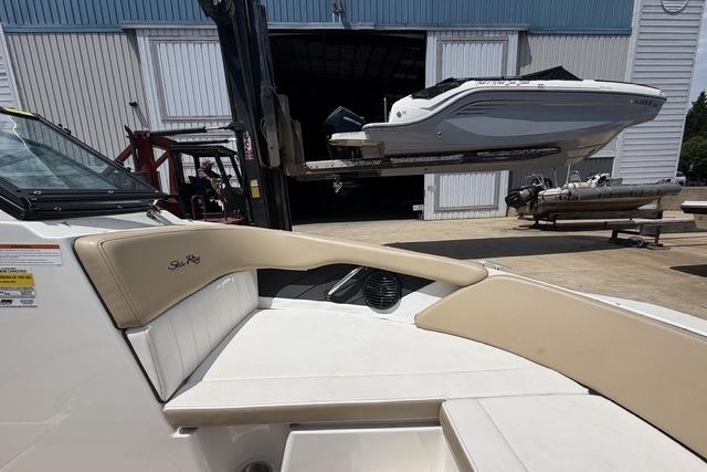 2018 Sea Ray SPX 190 boat interior with another boat being lifted in the background.