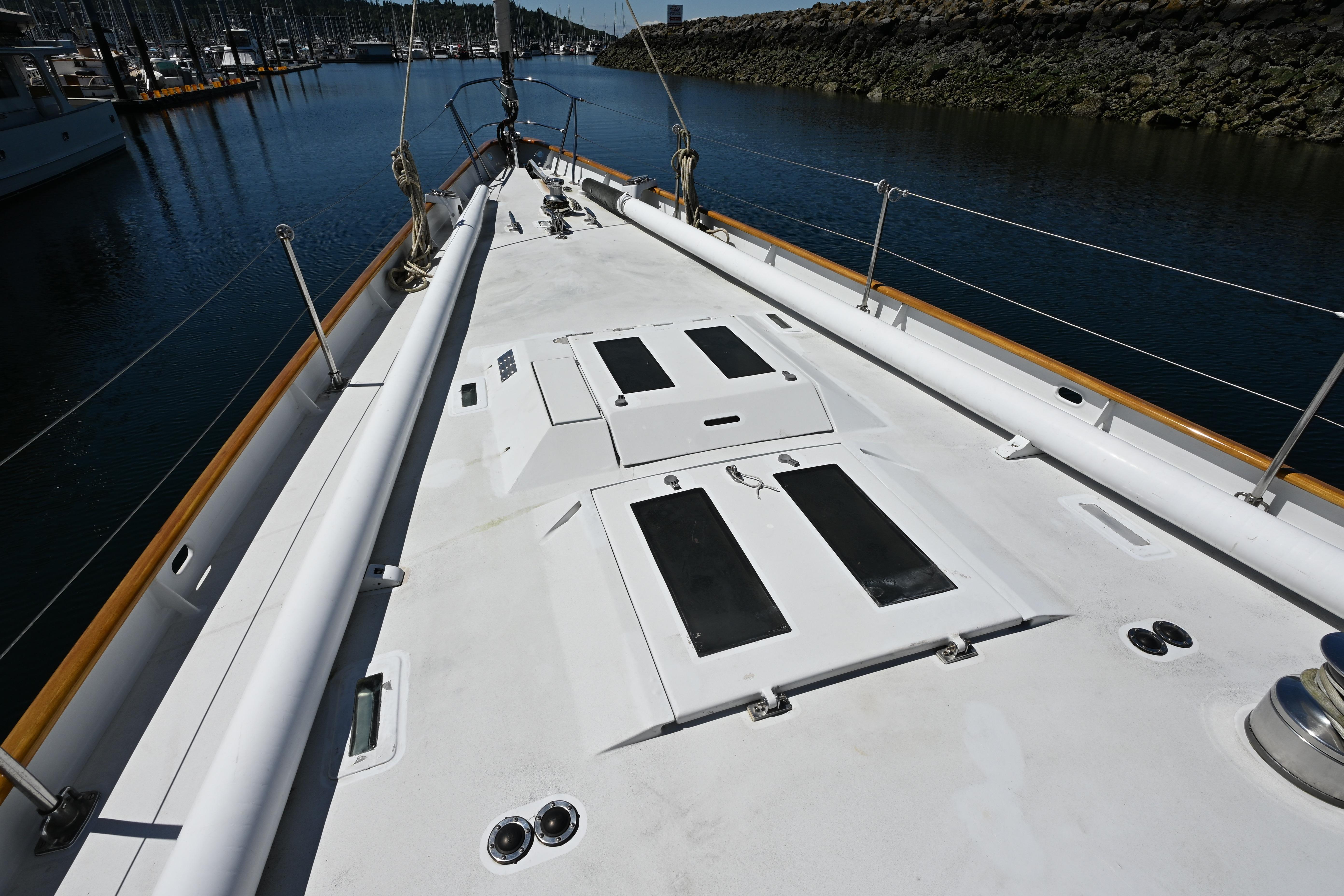 Deck view of 1968 Abeking & Rasmussen Tripp 74 yacht in a marina setting.