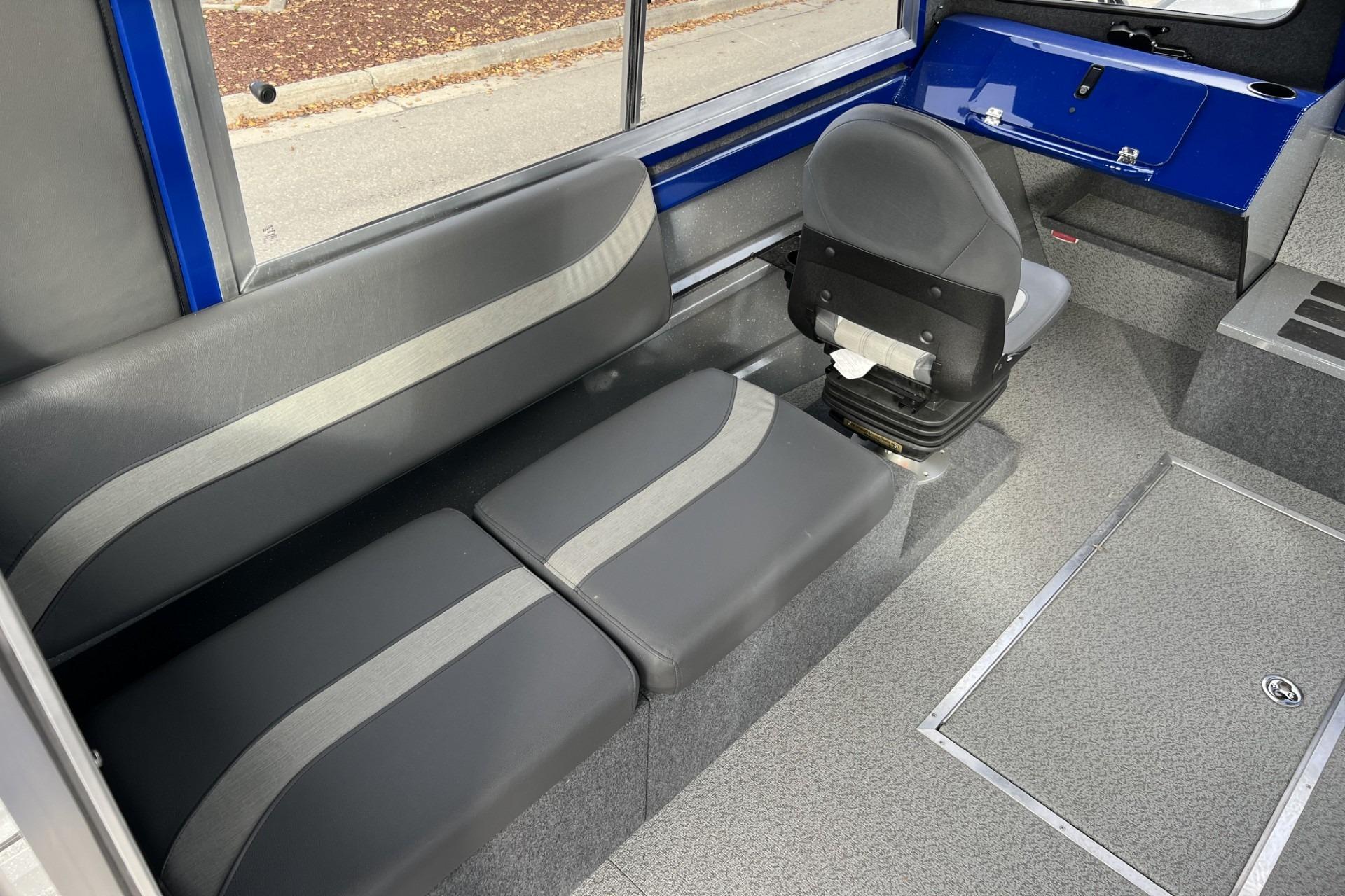 2024 Spartan 26 Maximus Pro XL interior with gray seating and blue accents.