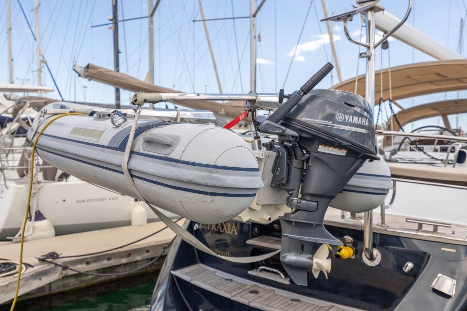 Inflatable boat with Yamaha motor on Discovery 55 yacht, 2008 model, docked at marina.