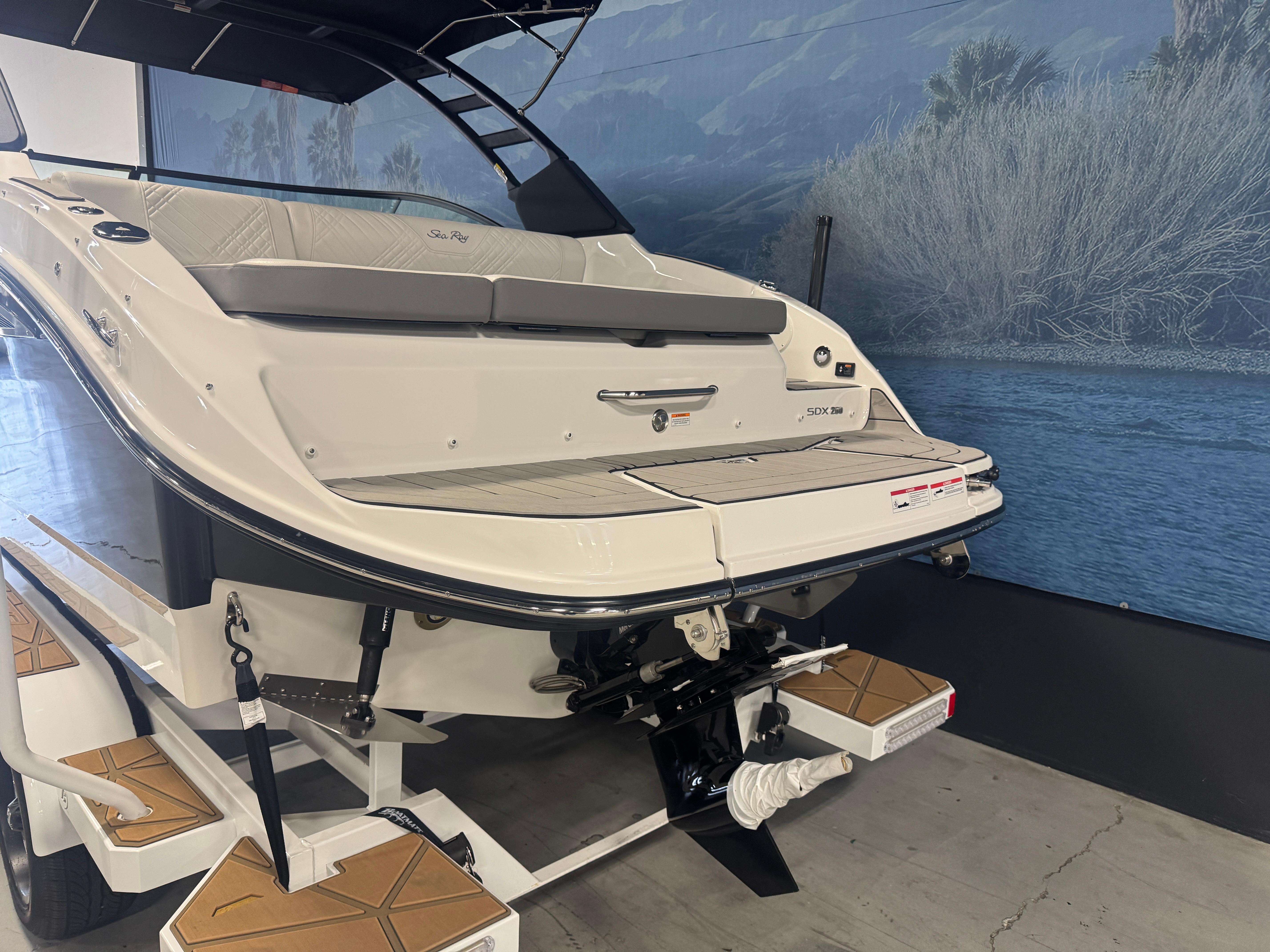 2025 Sea Ray SDX 250 boat on trailer, rear view, indoor display.