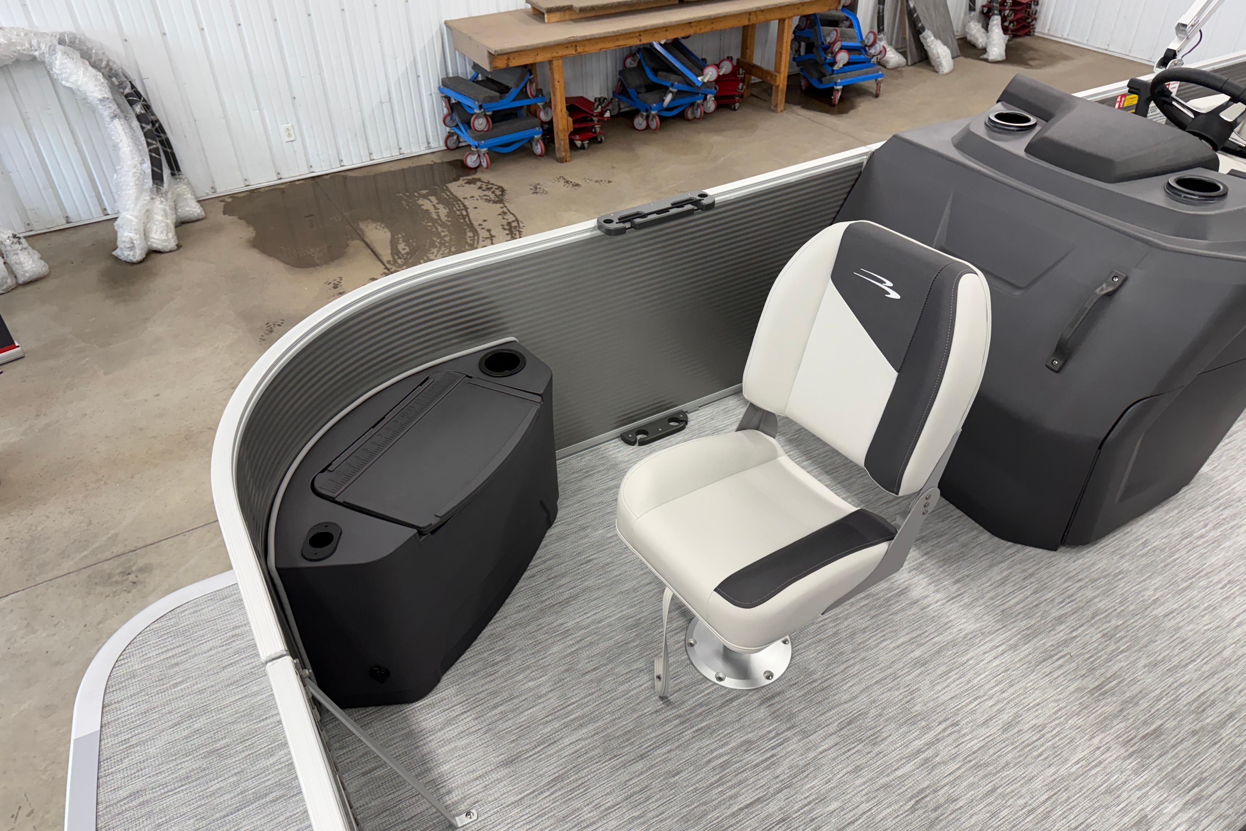 2026 Bennington 20 SF boat interior with swivel seat and storage compartment.