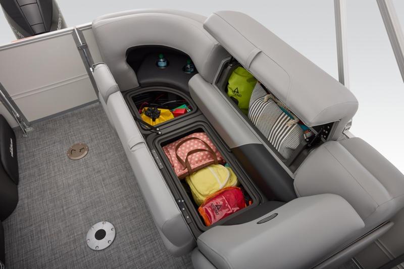 2026 Sun Tracker Party Barge 22 DLX interior storage with bags and accessories.