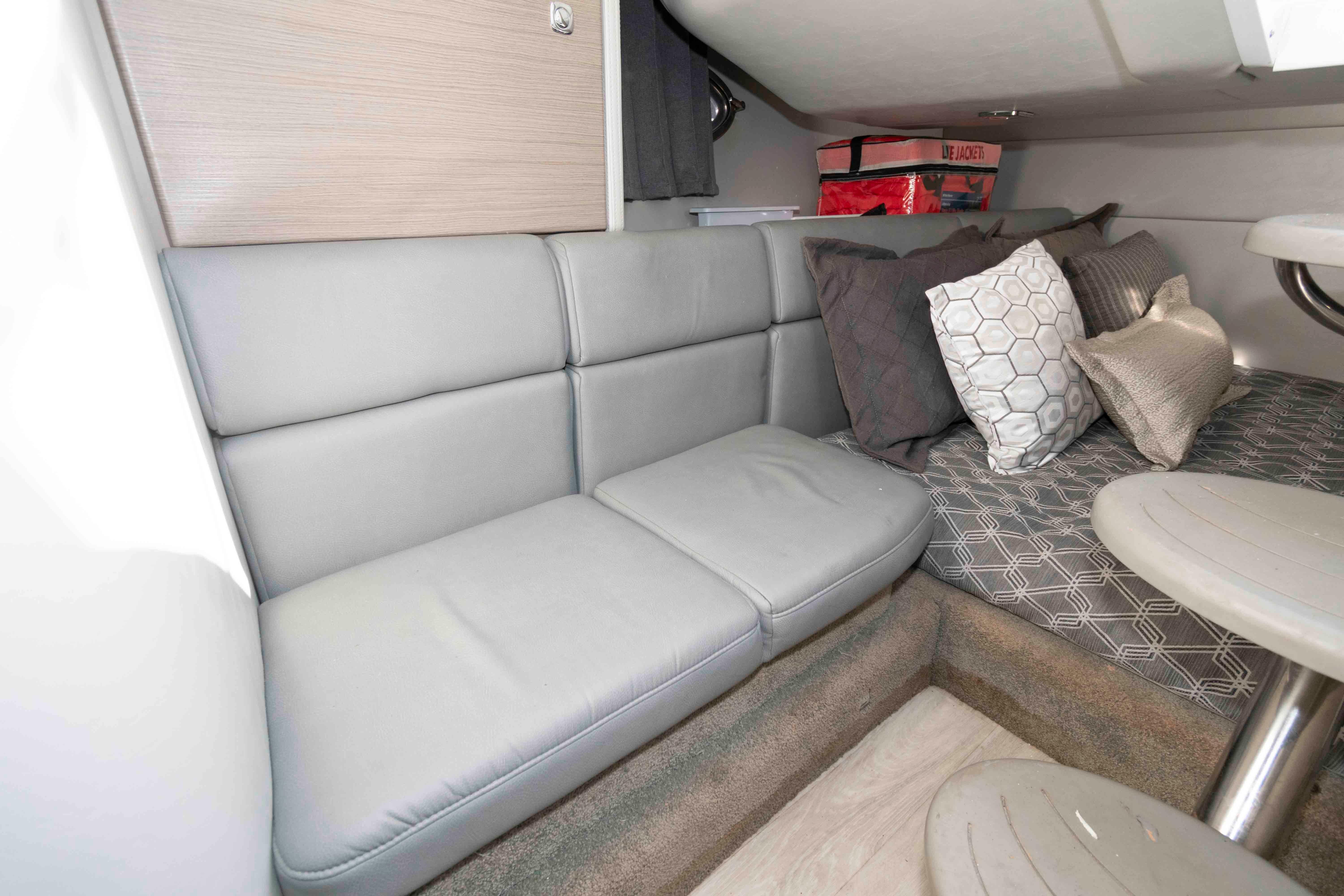 2018 Formula 350 Crossover Bowrider interior with gray seating and decorative pillows.