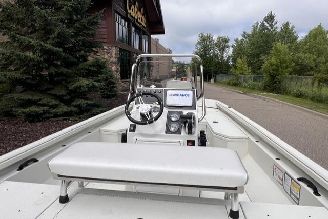 2023 Ranger RB190 boat with steering console, parked near Cabela's store, surrounded by trees.