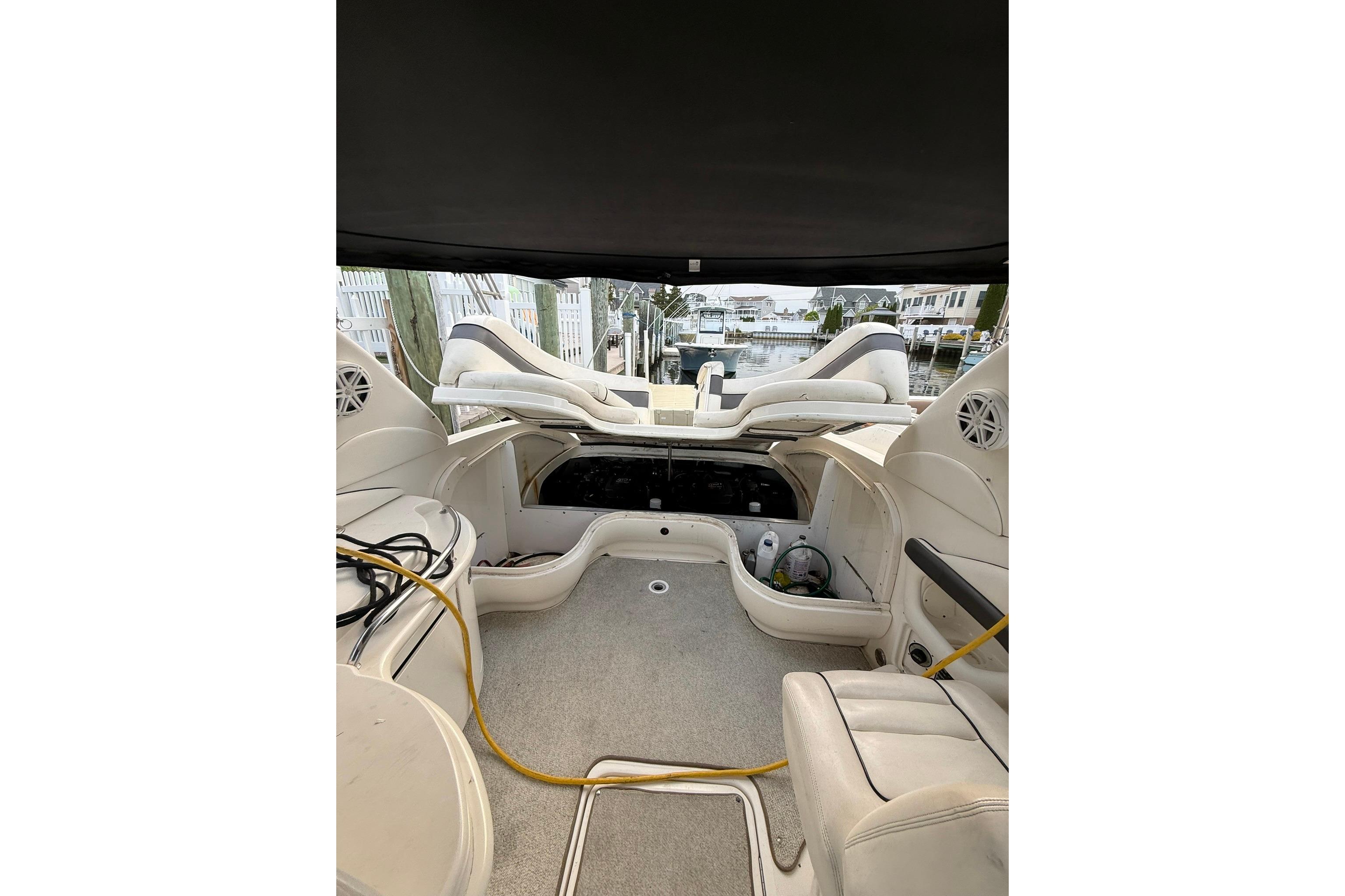 Interior view of a 2005 Sea Ray 290 SLX boat, showcasing seating and storage areas.