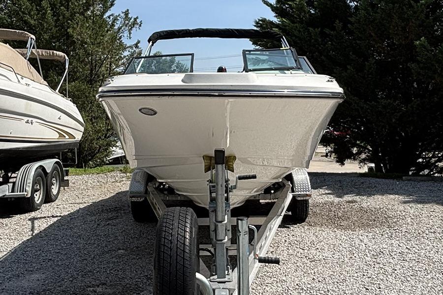 2019 Sea Ray SPX 230 Outboard boat on trailer, parked outdoors.