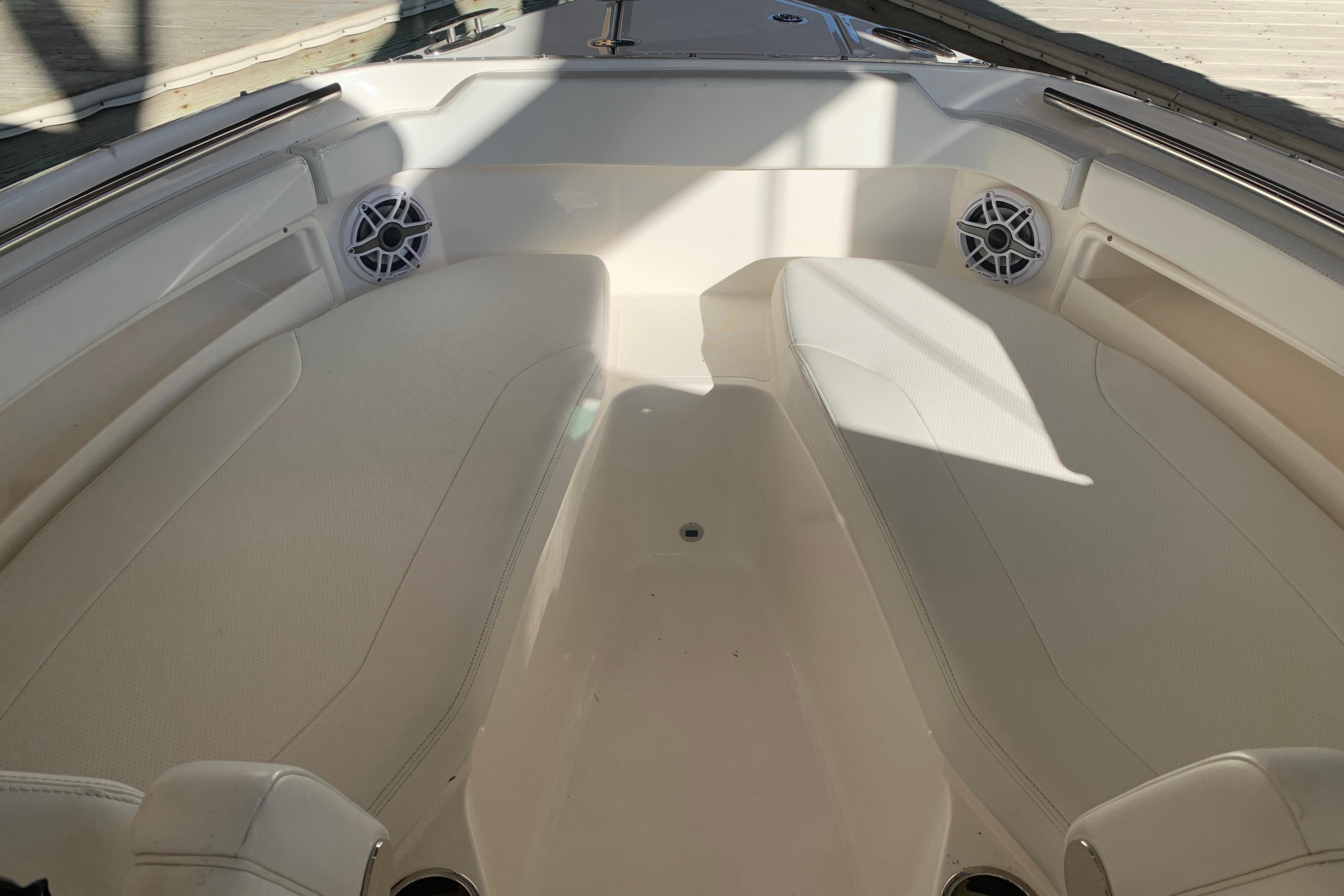 2023 Pursuit DC 266 Dual Console boat interior with cushioned seating and speakers.