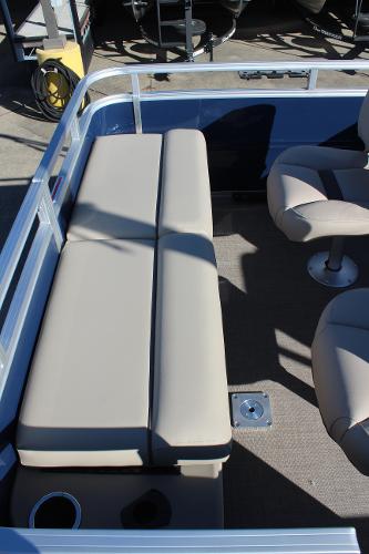 2025 Sun Tracker Fishin' Barge 22 DLX interior with beige seating and carpeted floor.