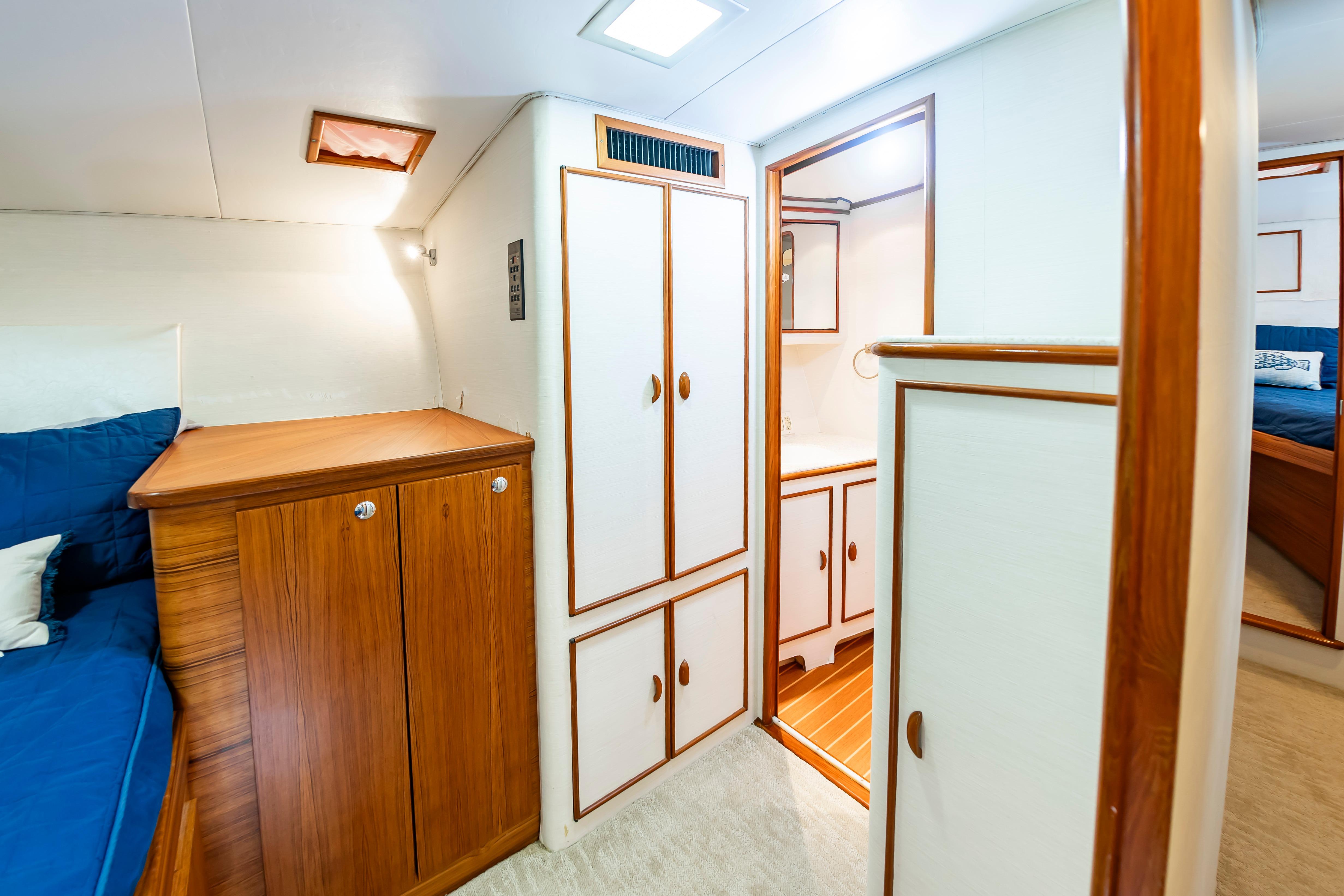 Interior of 1993 Custom Carolina Scarborough 56 Convertible yacht with wood cabinetry and cozy seating.