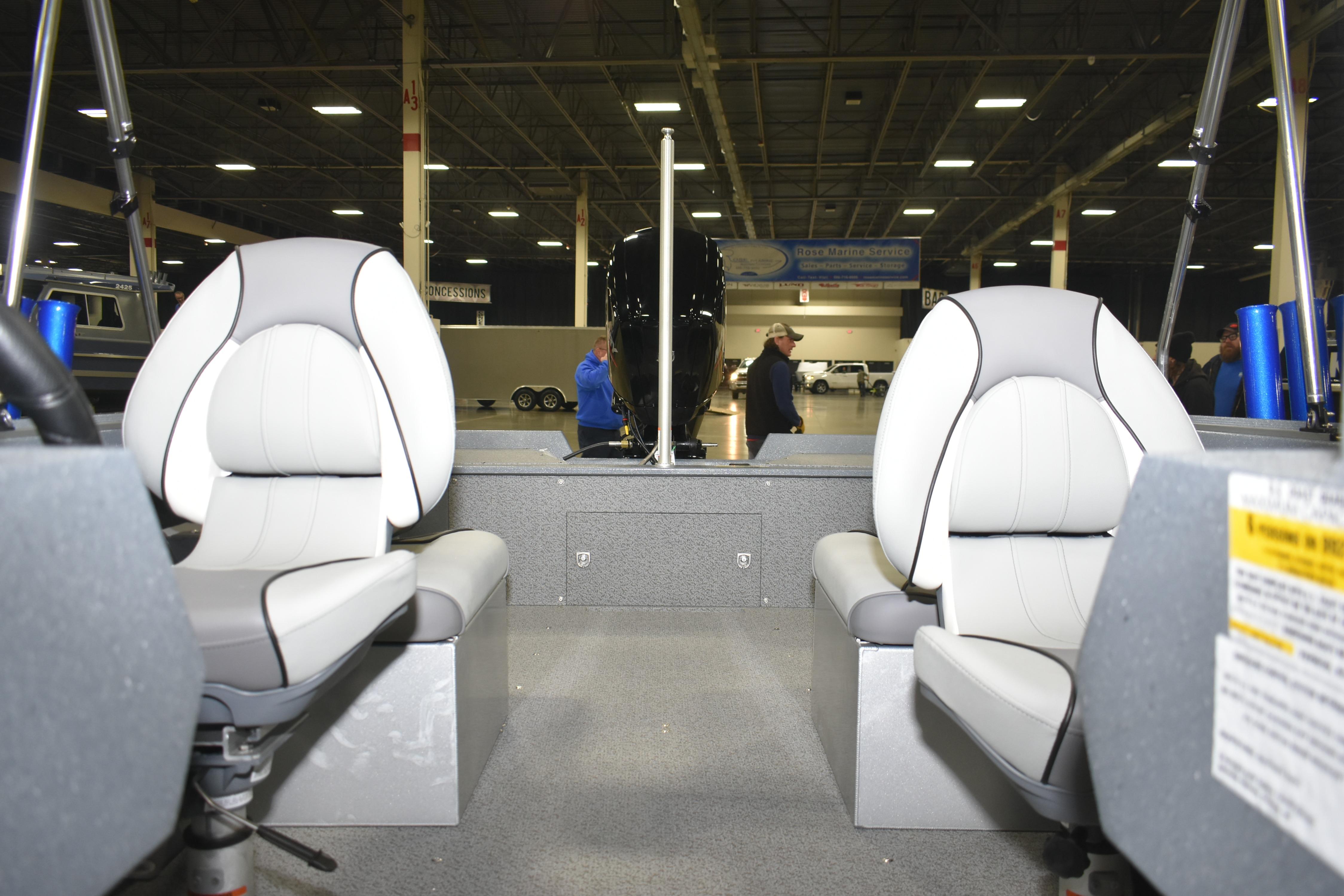 Interior of 2026 KingFisher 1825 Falcon boat with two white seats in a showroom.