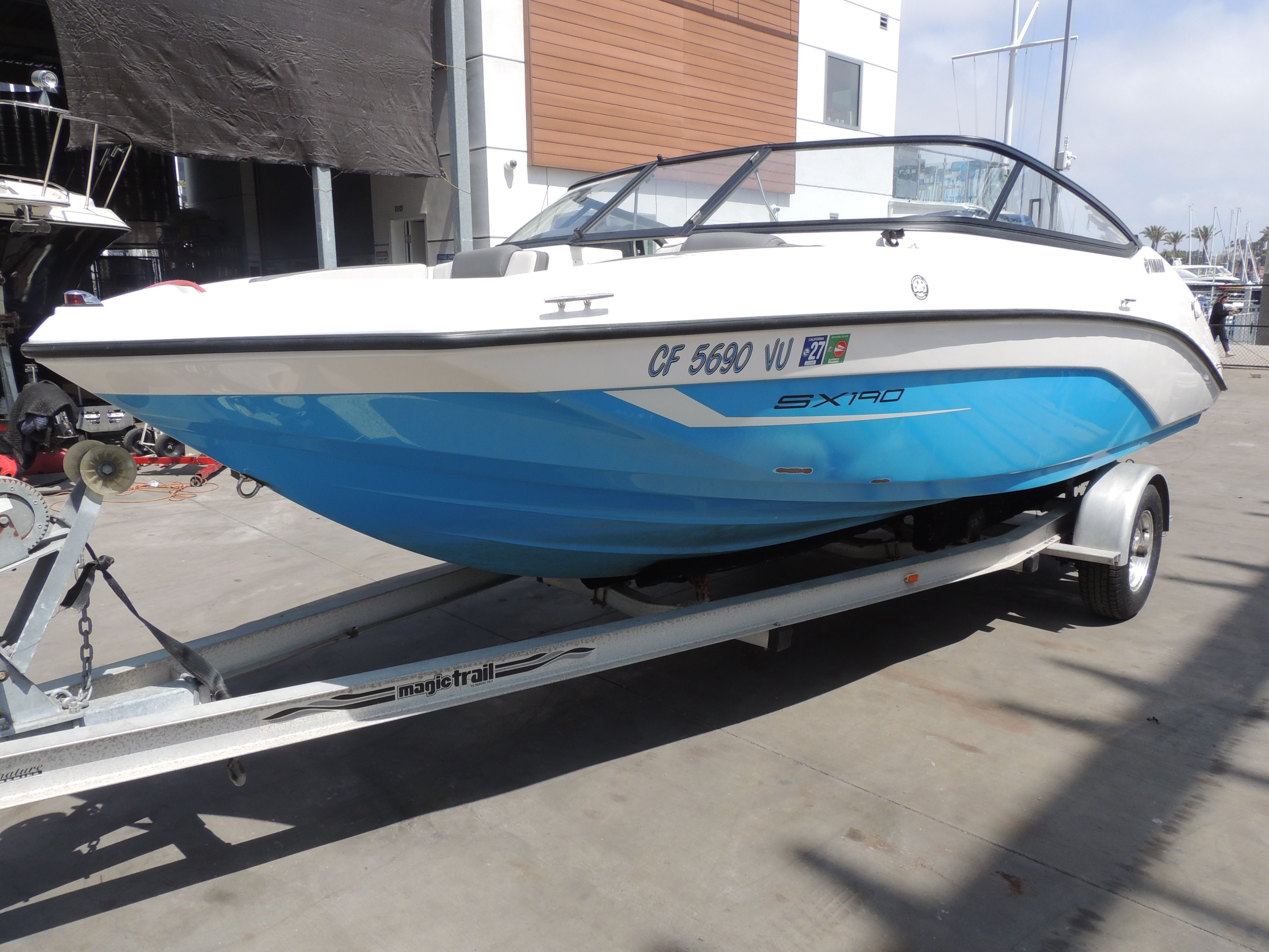 2023 Yamaha SX190 boat on trailer at marina.