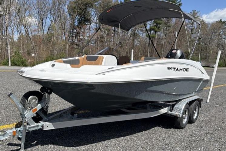 2026 Tahoe 1950 boat on trailer, parked outdoors with canopy.