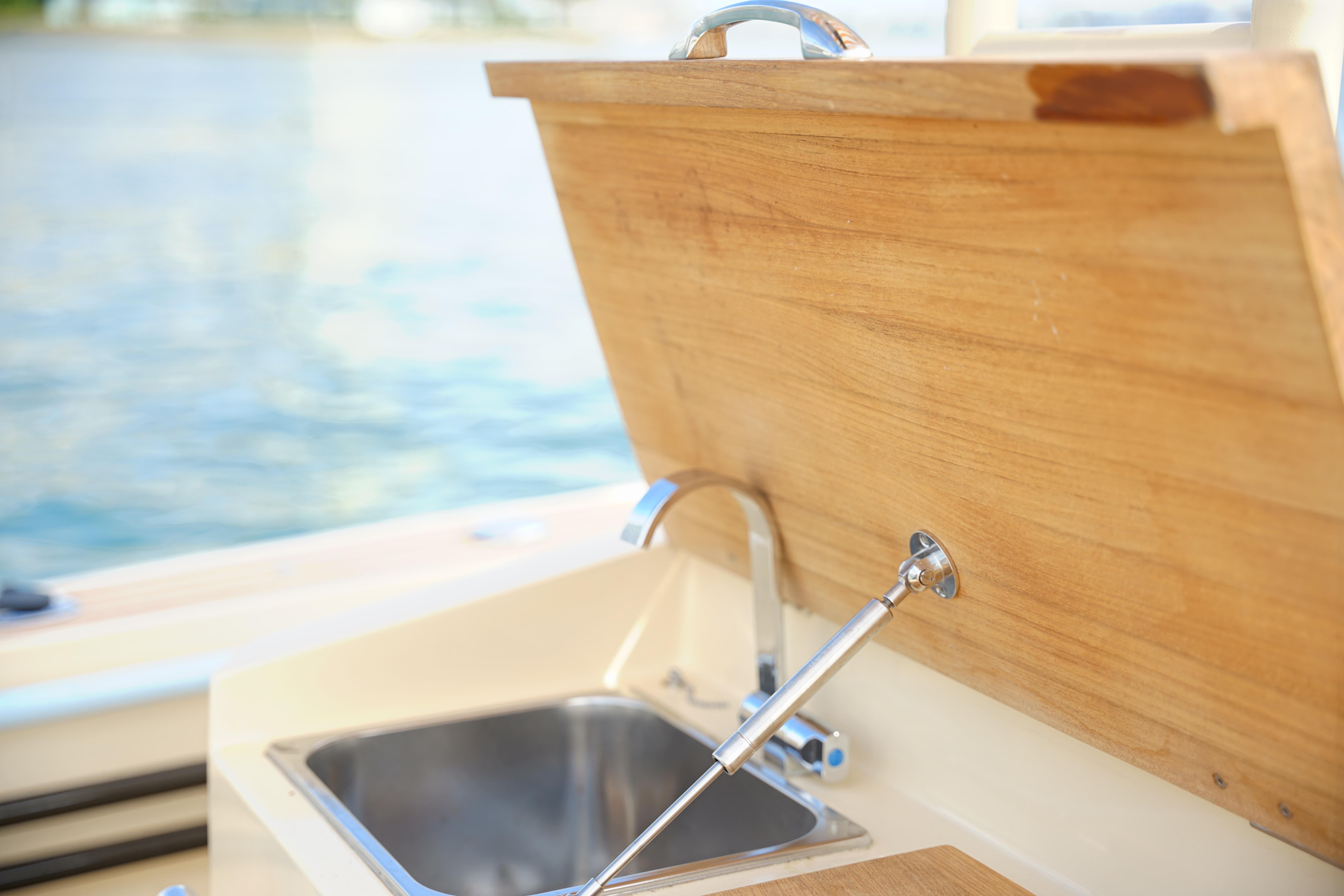 Lilybaeum Levanzo 25 Lounge Deck 2026 boat sink with wooden cover open.