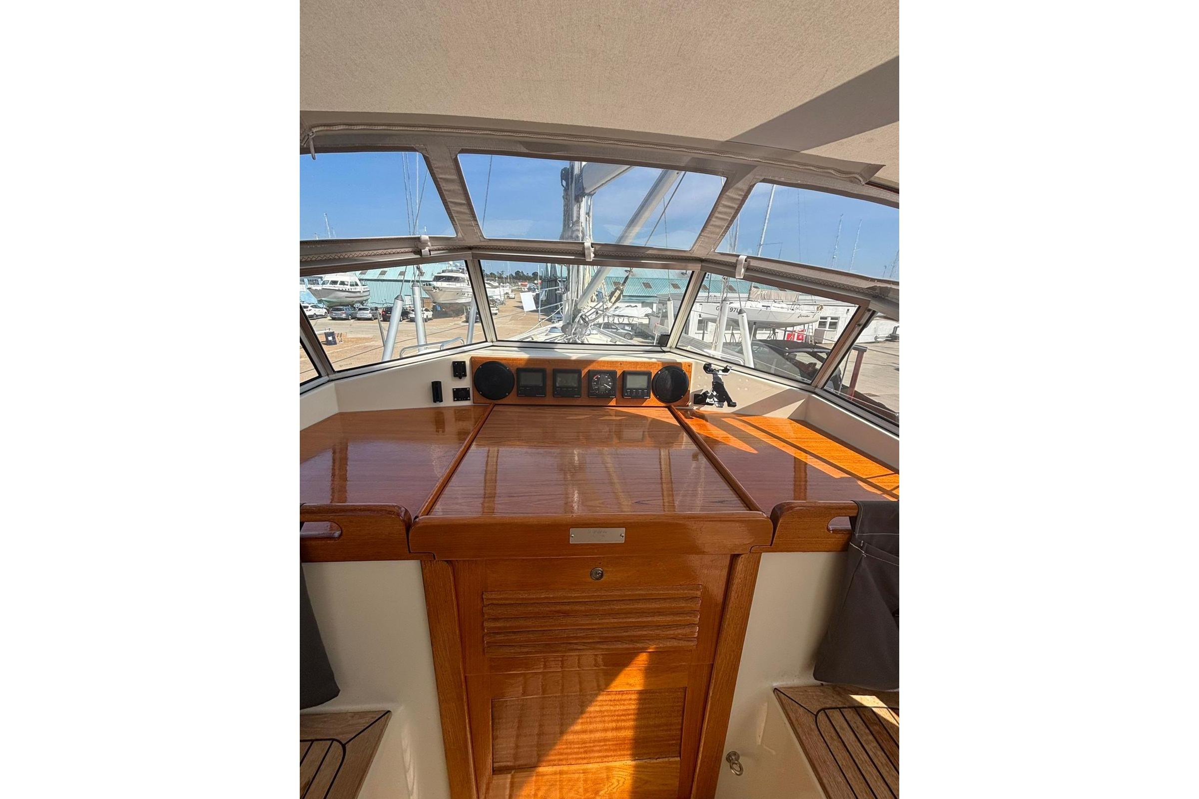 Cockpit of 1997 Najad 361 yacht with polished wood finish and navigation instruments.