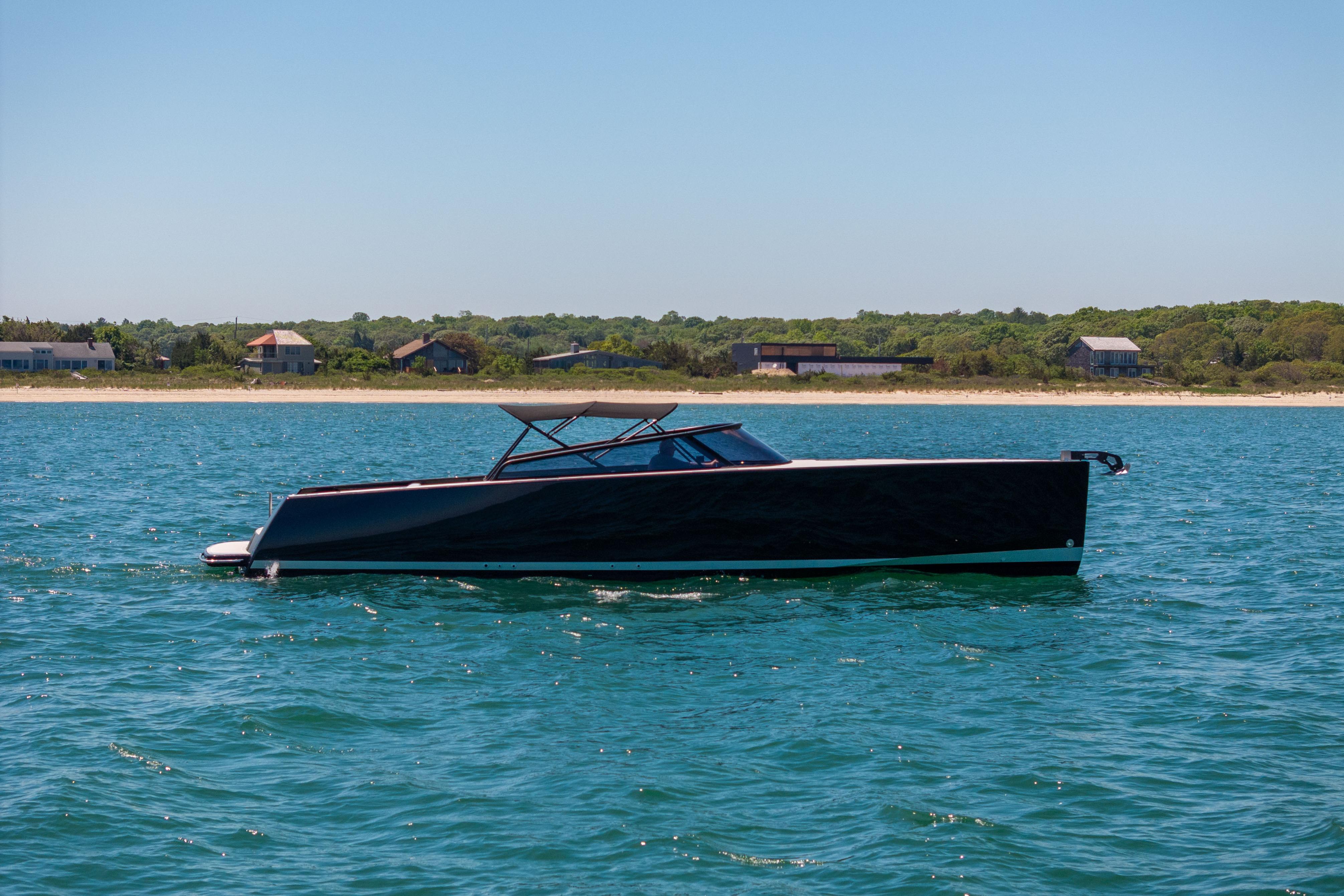 2016 VanDutch 40 yacht cruising on serene blue waters near a coastal landscape.