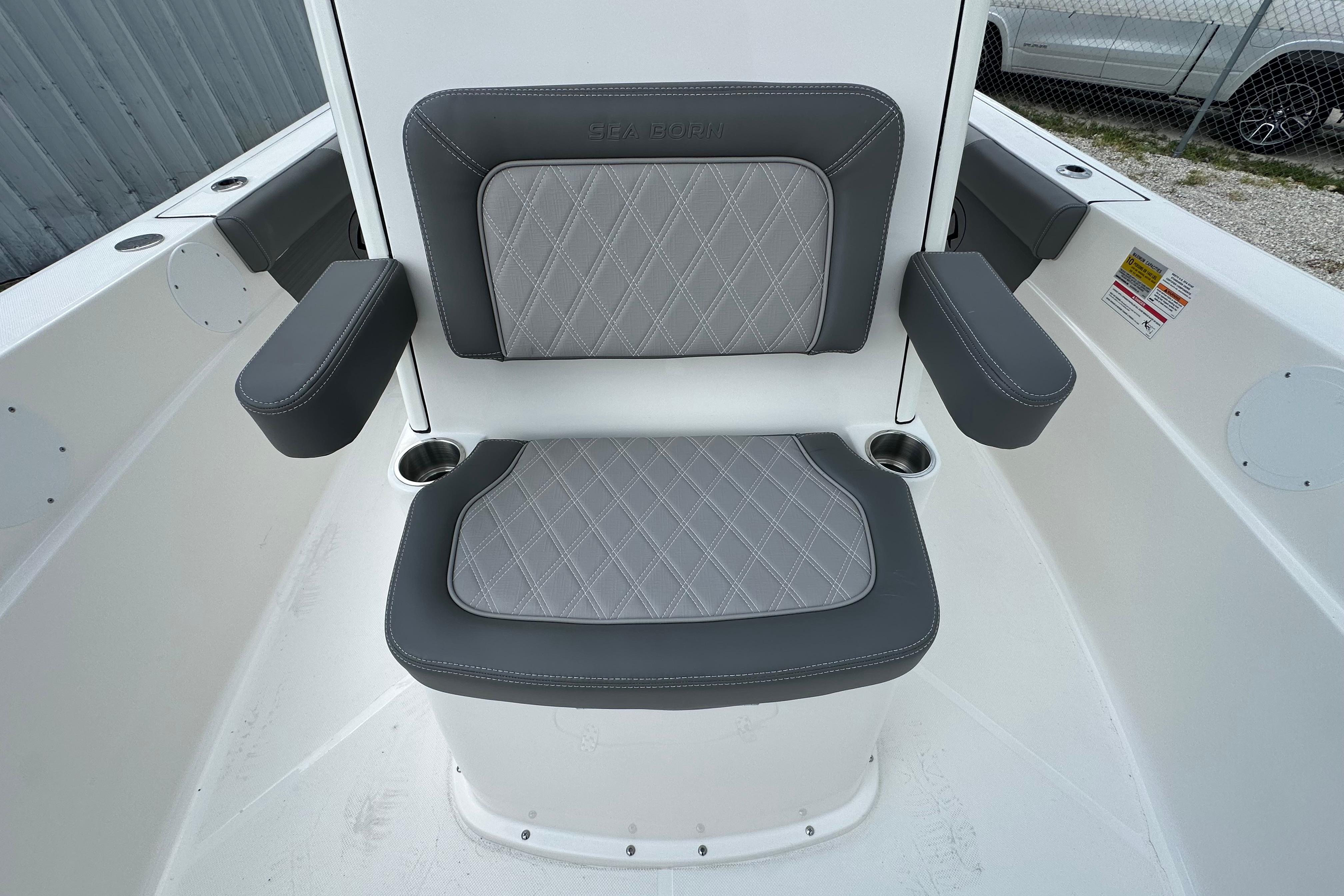 2027 Sea Born LX24 Center Console boat seat with gray diamond-stitched upholstery and armrests.