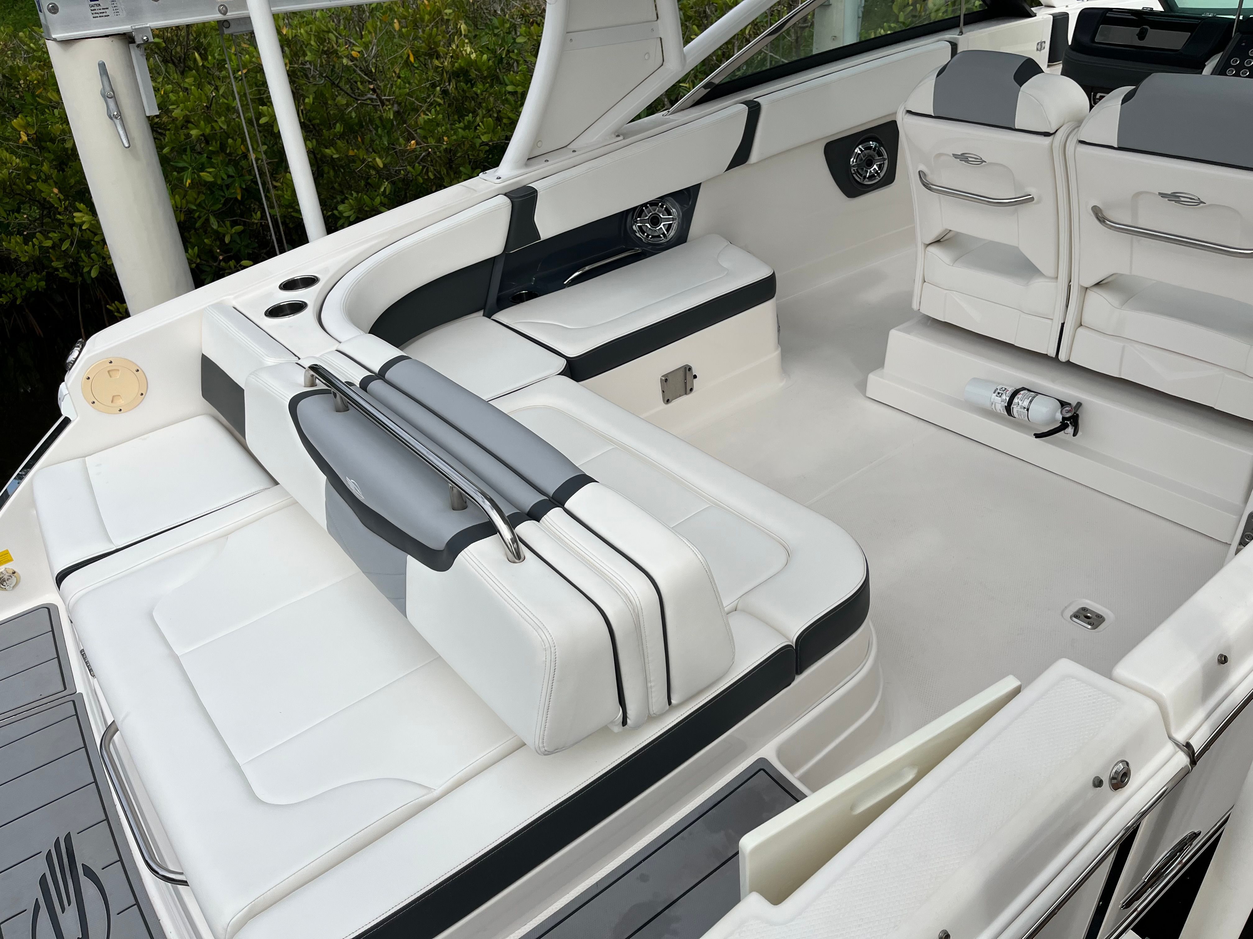 The image shows the cockpit of a 2023 Chaparral 28 OSX boat with white upholstery.