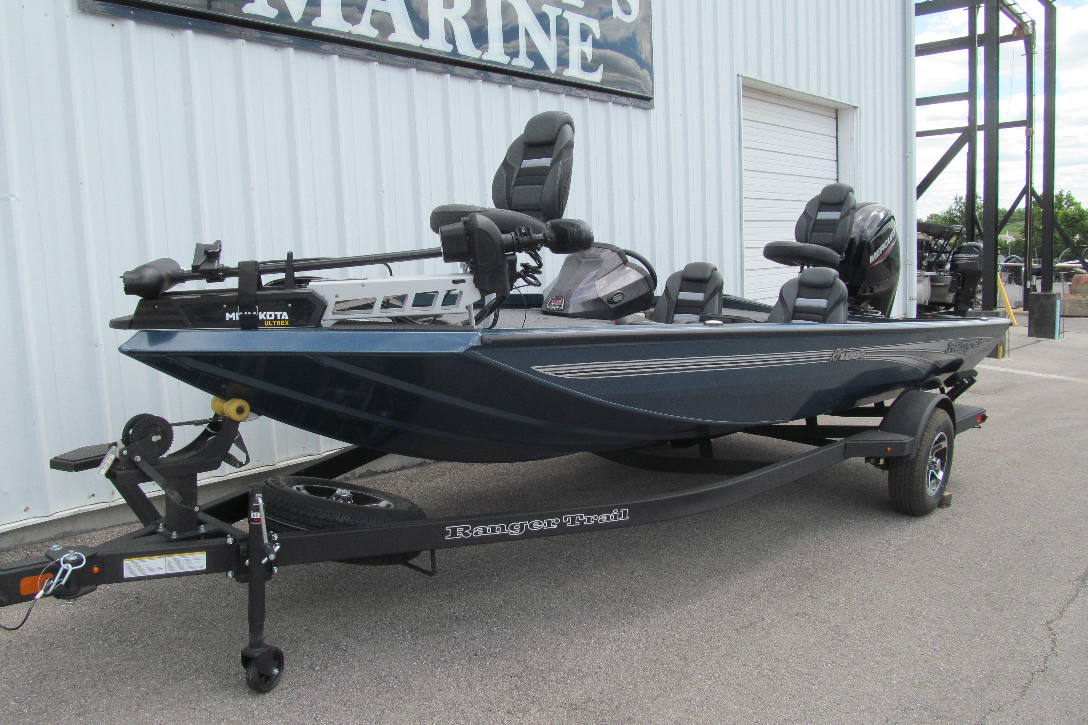 2026 Ranger RT188C fishing boat on trailer, parked outside a marine shop.