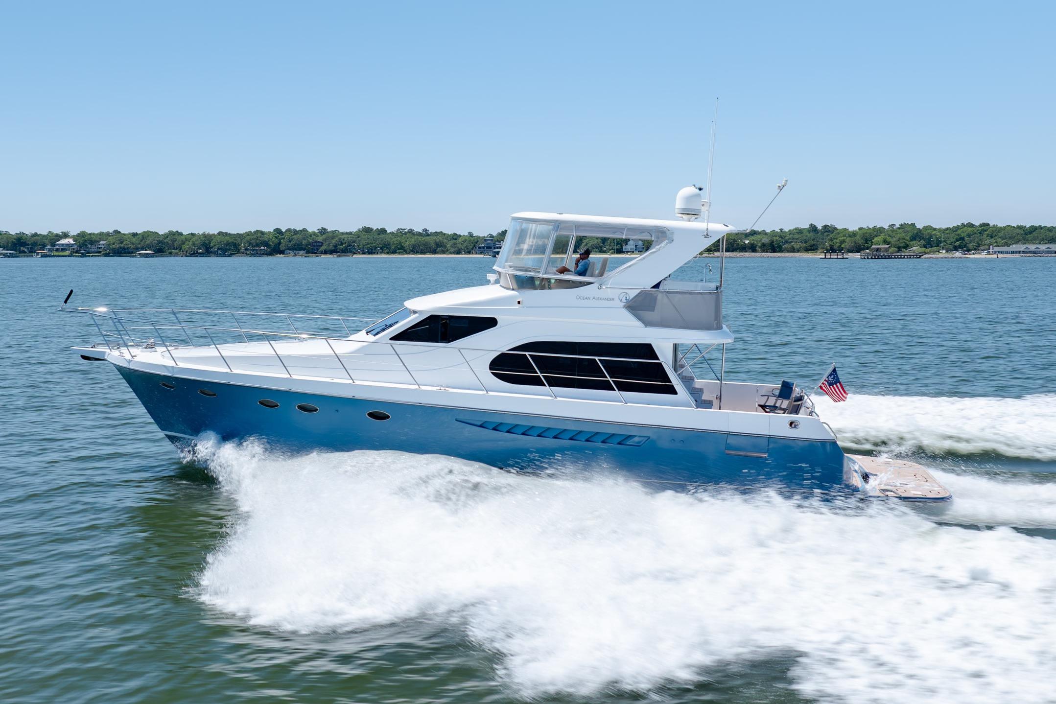 Ocean Alexander yacht cruising on a sunny day, displaying sleek design and powerful performance.
