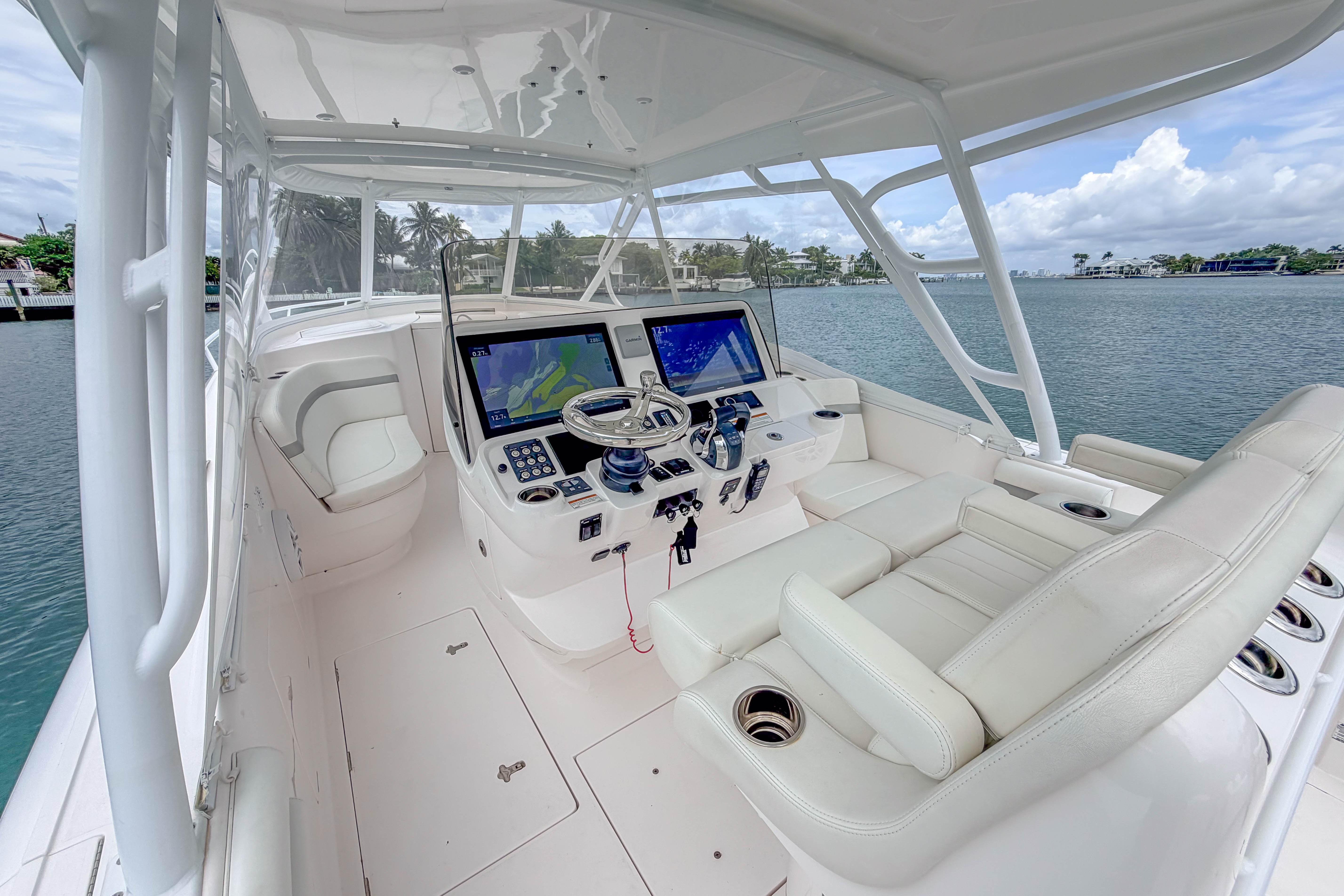 Luxurious 2021 Intrepid 409 Valor yacht cockpit with advanced navigation systems and plush seating.