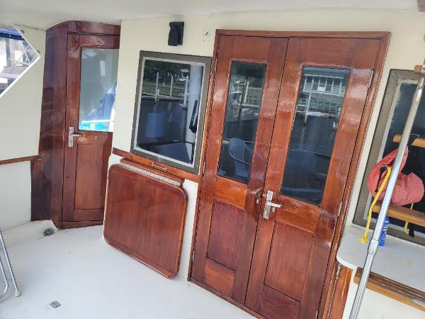 Interior of a 1980 Hatteras 53 Yacht Fisherman with wooden doors and windows.