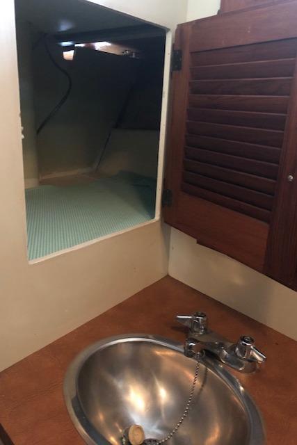 Interior of 1978 Tollycraft 34 Sport Sedan with sink and storage.