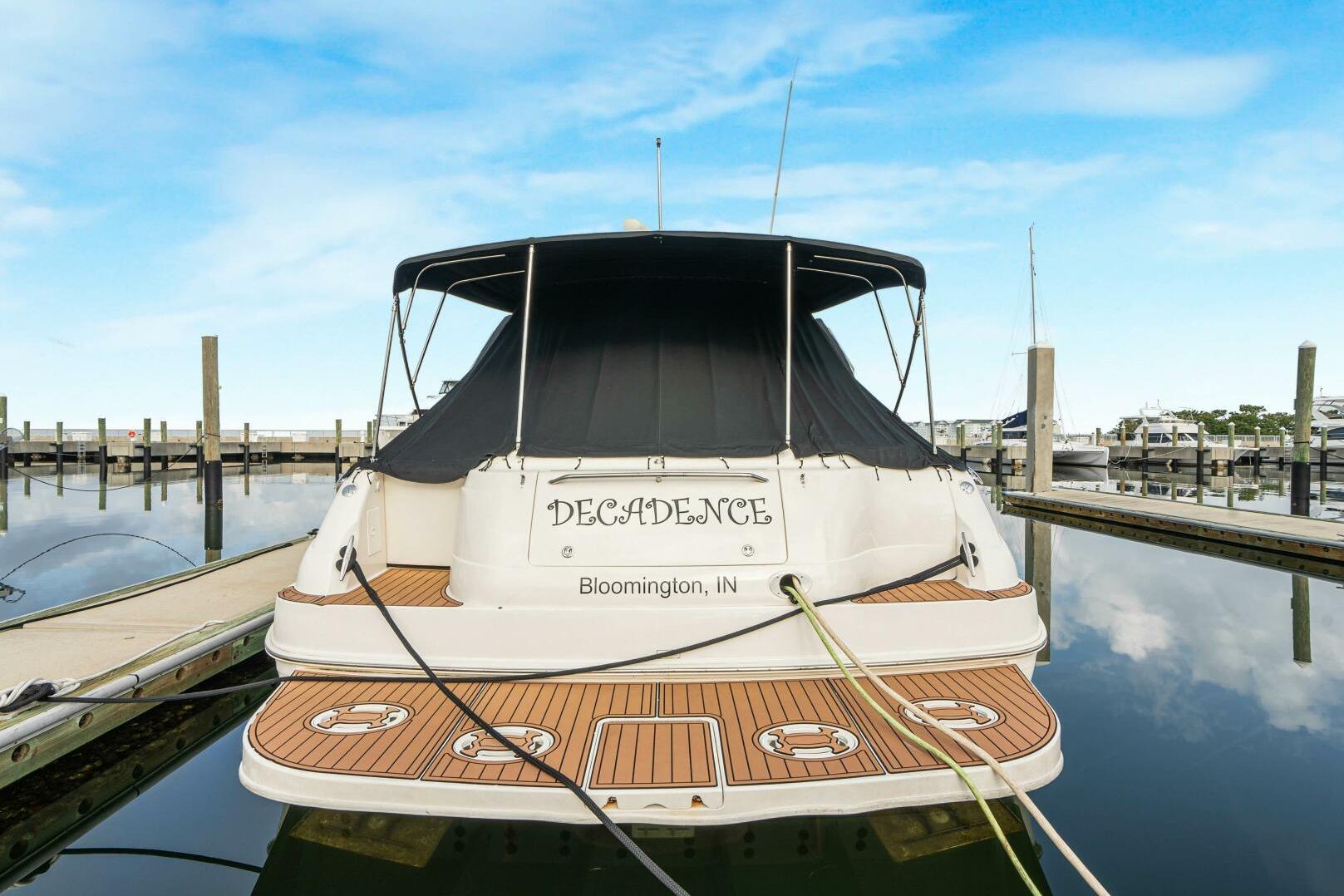 2003 Sea Ray Sundancer 460 yacht docked, rear view with "Decadence" name, Bloomington, IN.